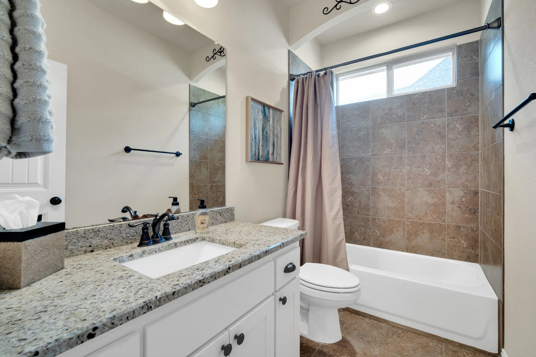 First floor full bathroom. Granite counter top with tile shower tub combonation.