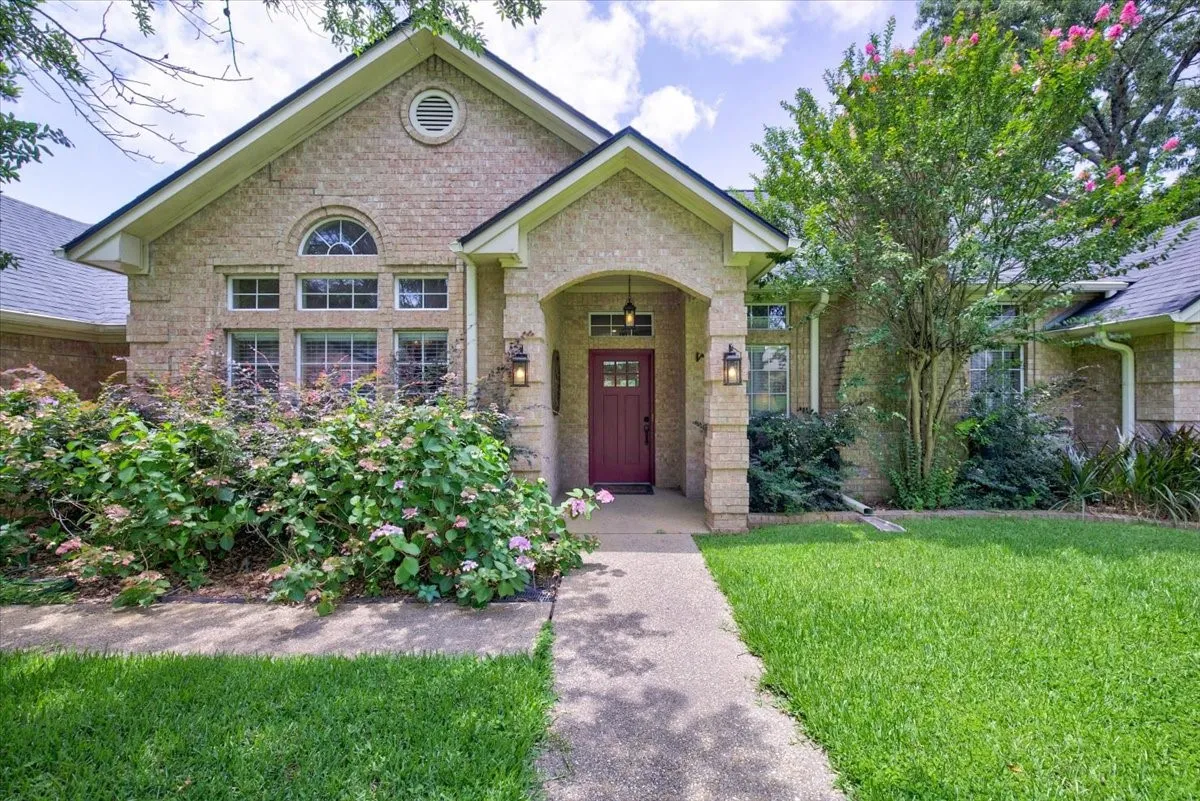 Traditional brick exterior featuring a covered entry