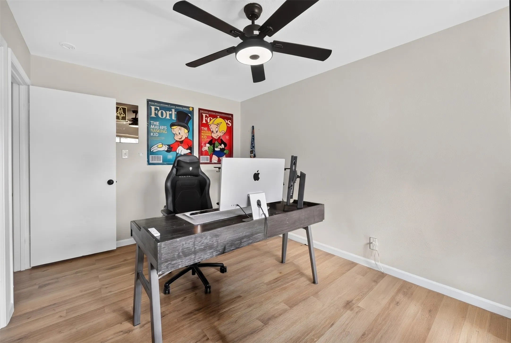 Light-toned wood-finish flooring complements the neutral wall color