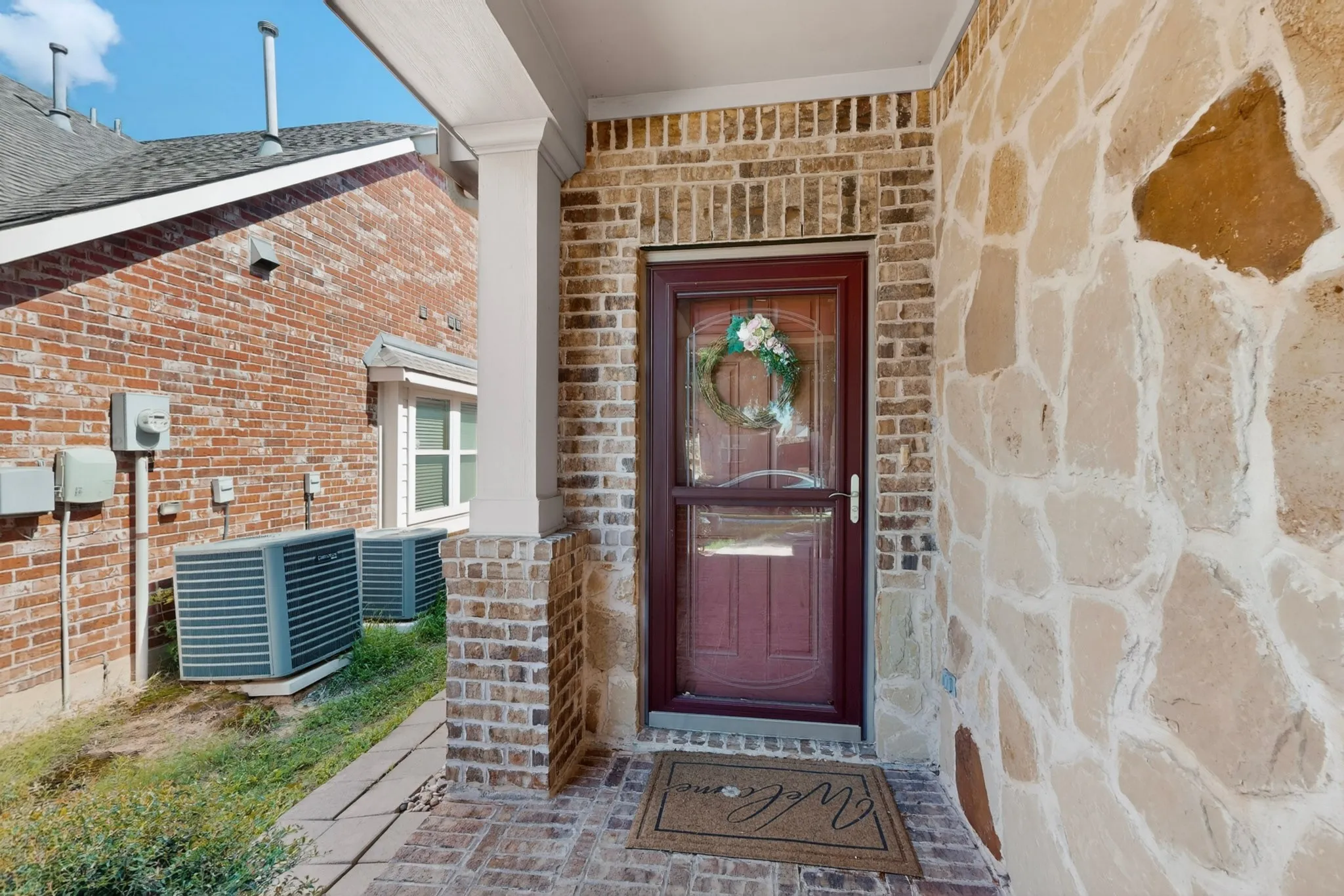 Stone and brick facade with a covered entry