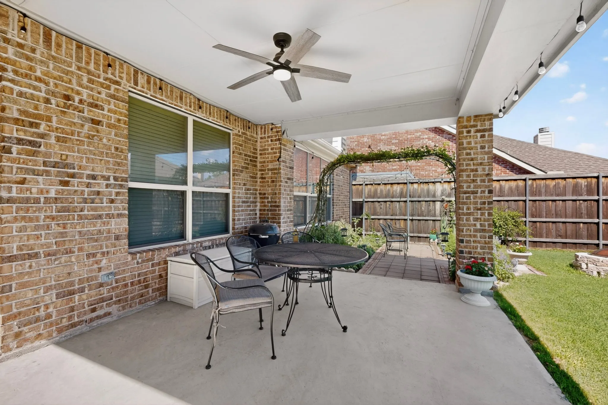 Covered patio featuring a ceiling fan, recessed lighting, and brick support columns