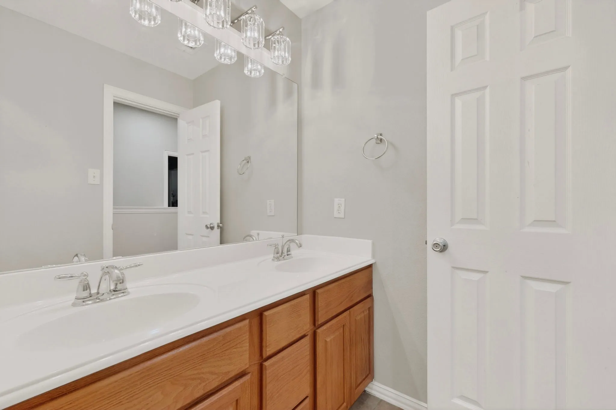 Dual vanity with chrome fixtures and white integrated sinks