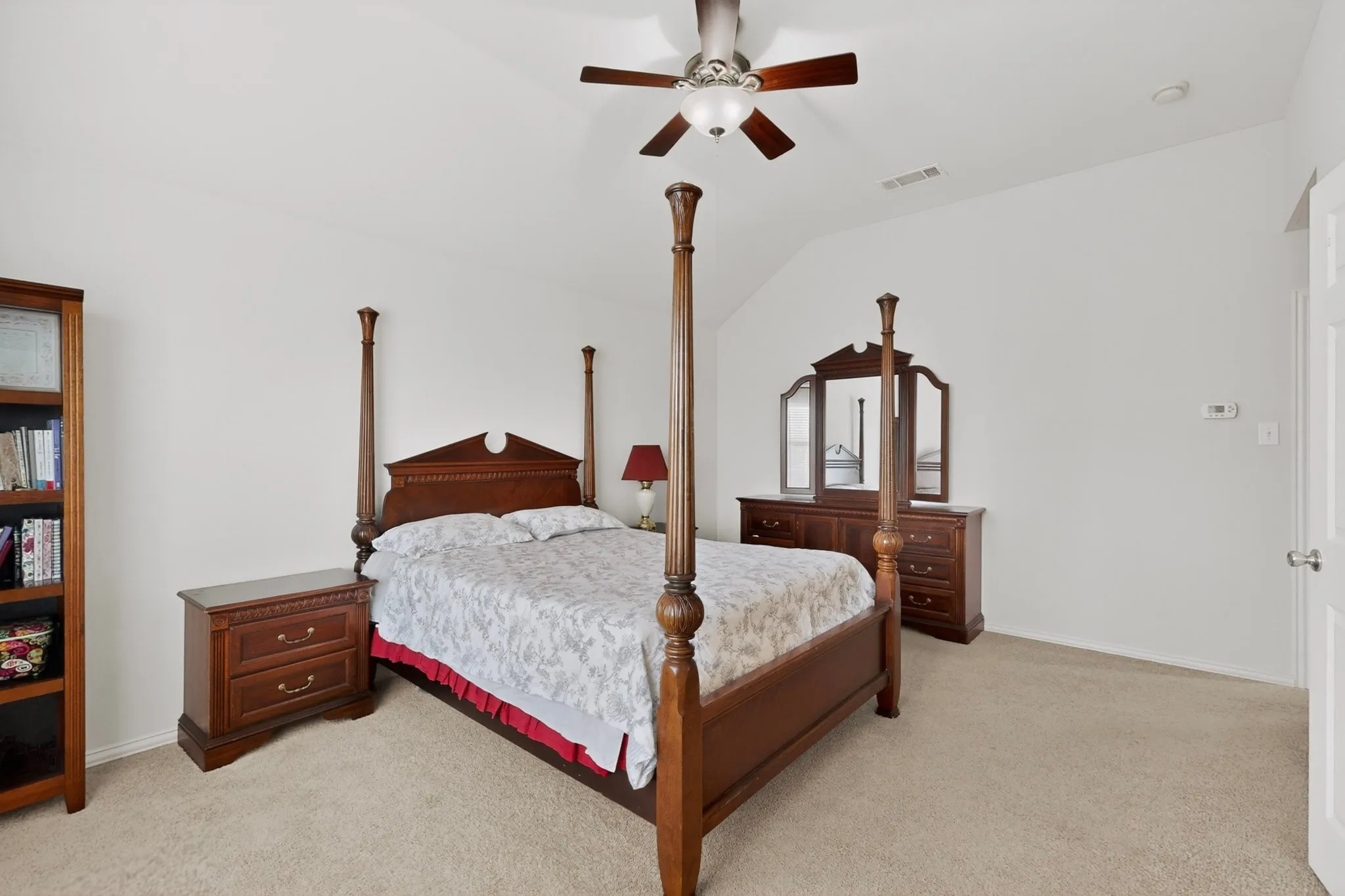 Spacious bedroom featuring vaulted ceilings, a ceiling fan with integrated lighting, recessed lighting, and neutral carpeting