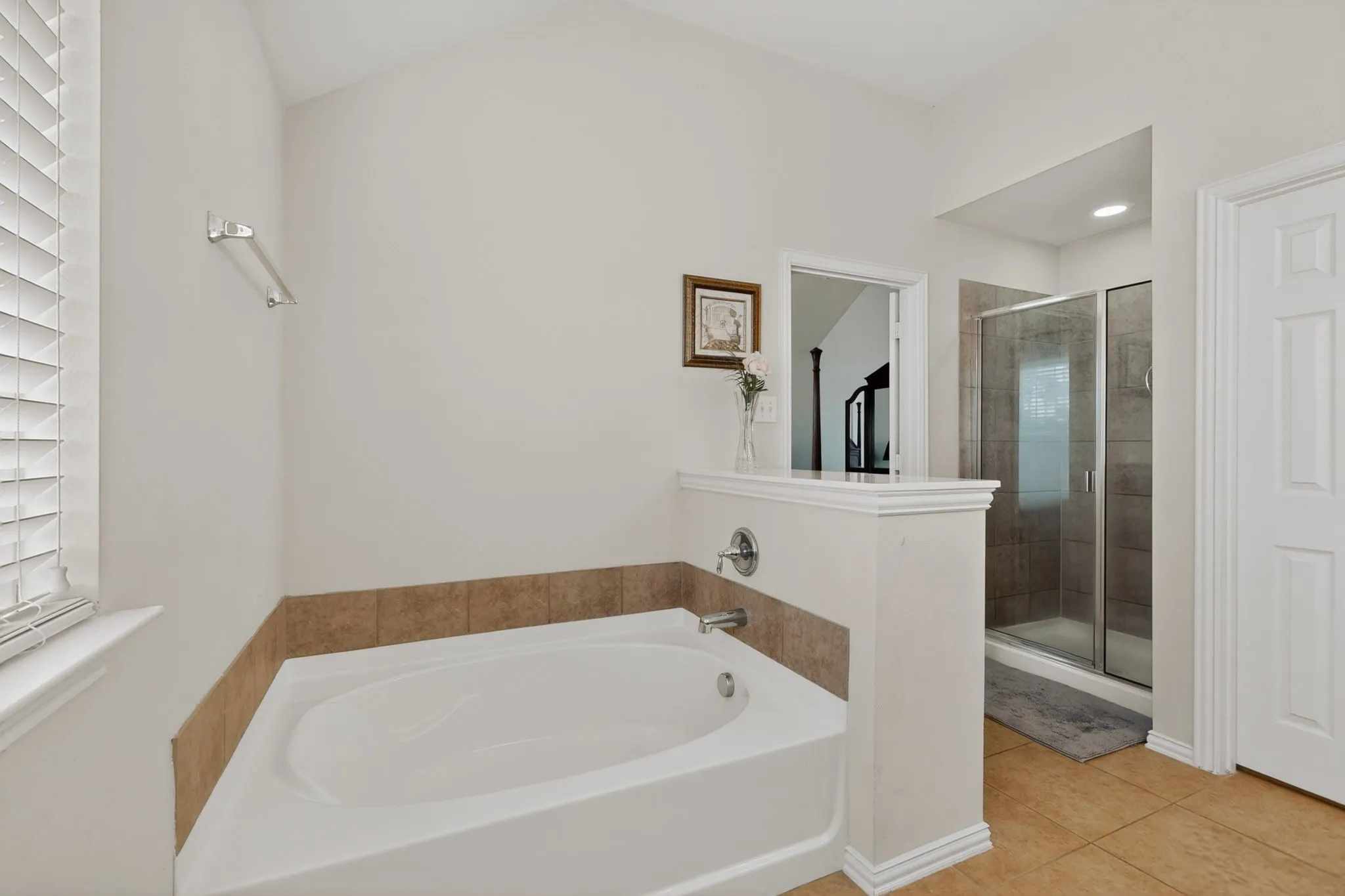 Soaking tub with tile surround and chrome fixtures