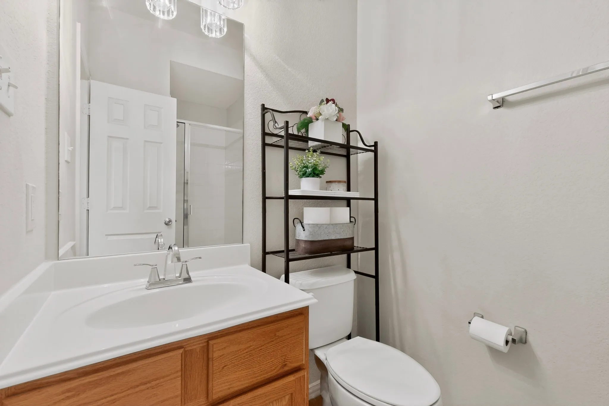 Bathroom featuring a wood-finish vanity with an integrated sink and chrome faucet