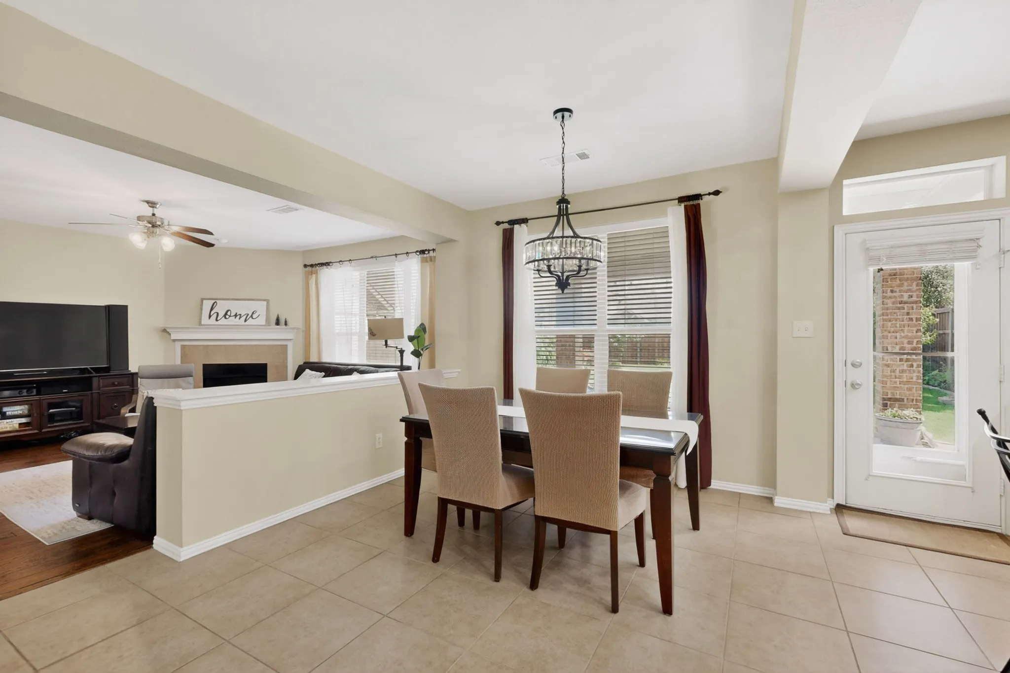 Dining area with tile flooring and a decorative chandelier