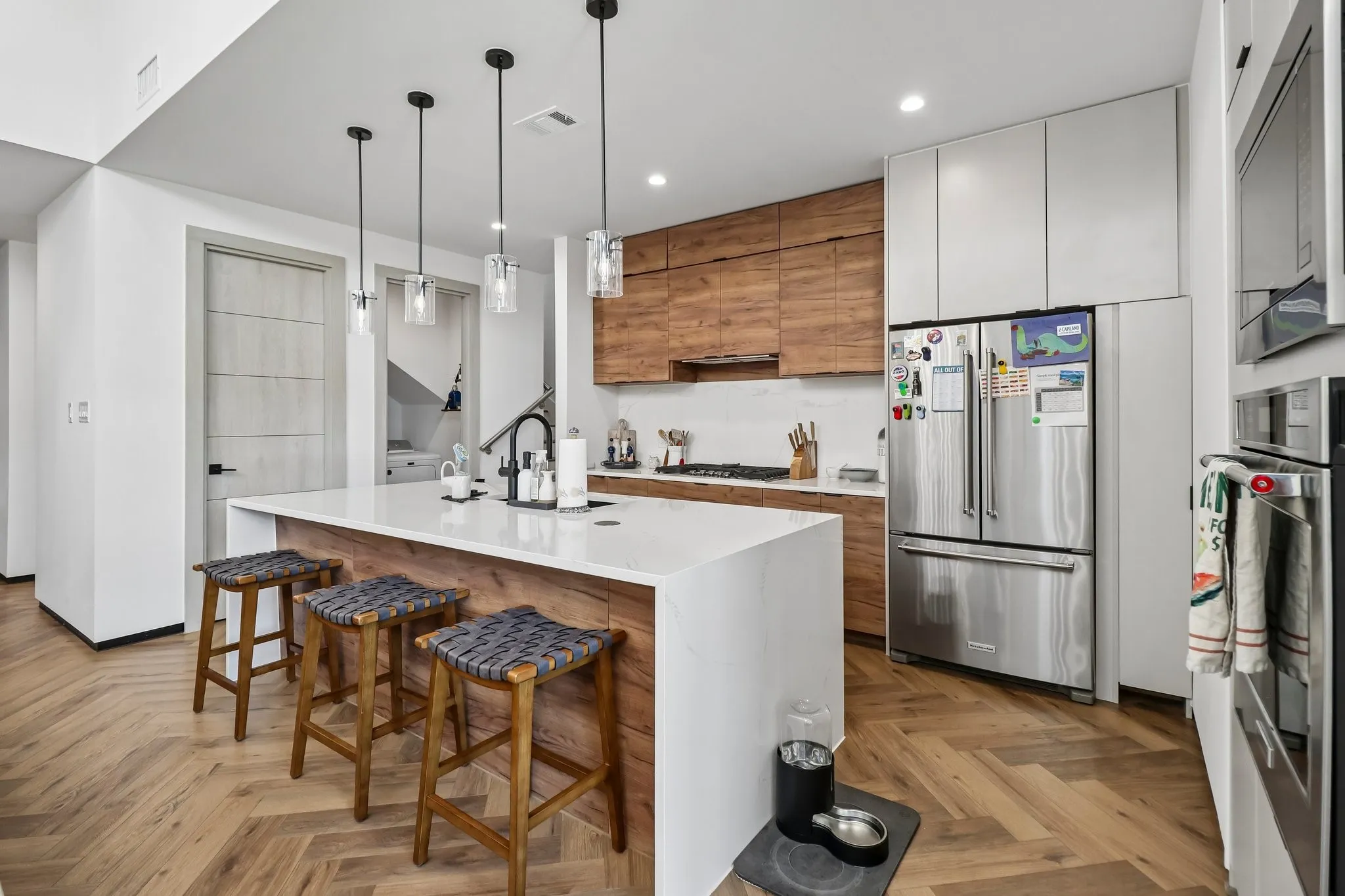 Beautiful Kitchen with Breakfast Bar and Waterfall Countertop on Kitchen Island