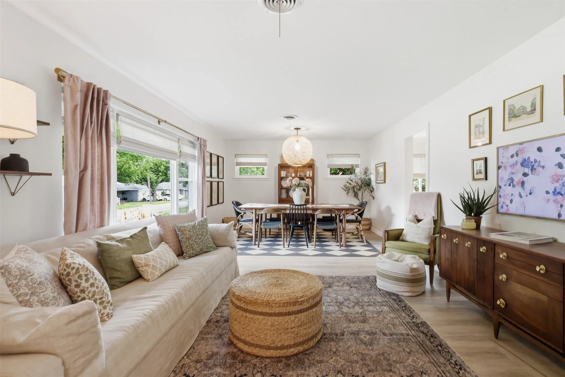 Large living room/dining room area with window that looks out the front of the home.