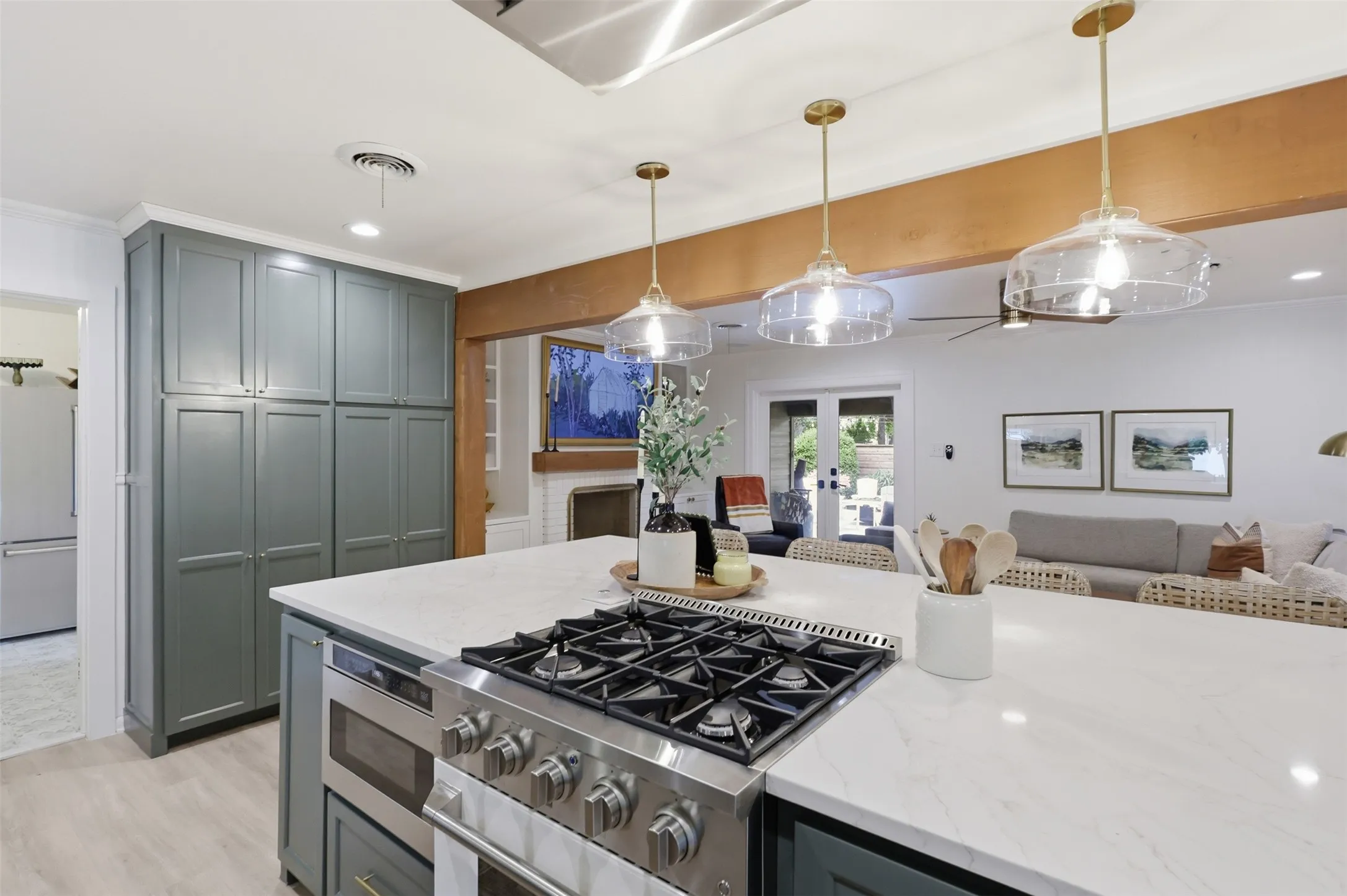 Industrial gas range and microwave drawer located in Island.  Range vents thru ceiling but is flat so as not to obstruct the open concept floor plan.