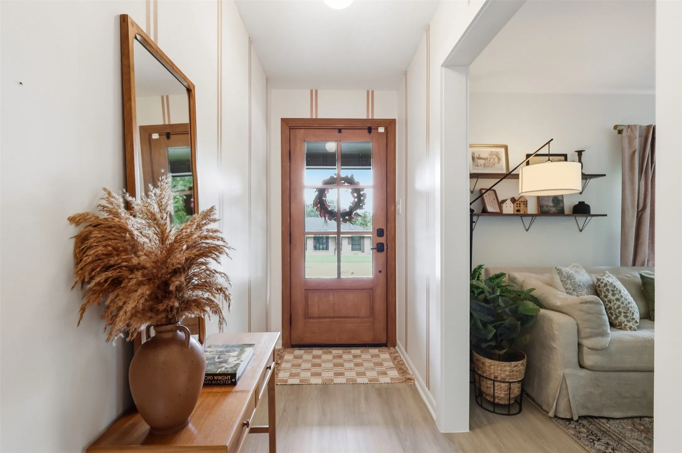 Alternate View of Entry leading to the front door and showcasing entry to the living room/dining room.