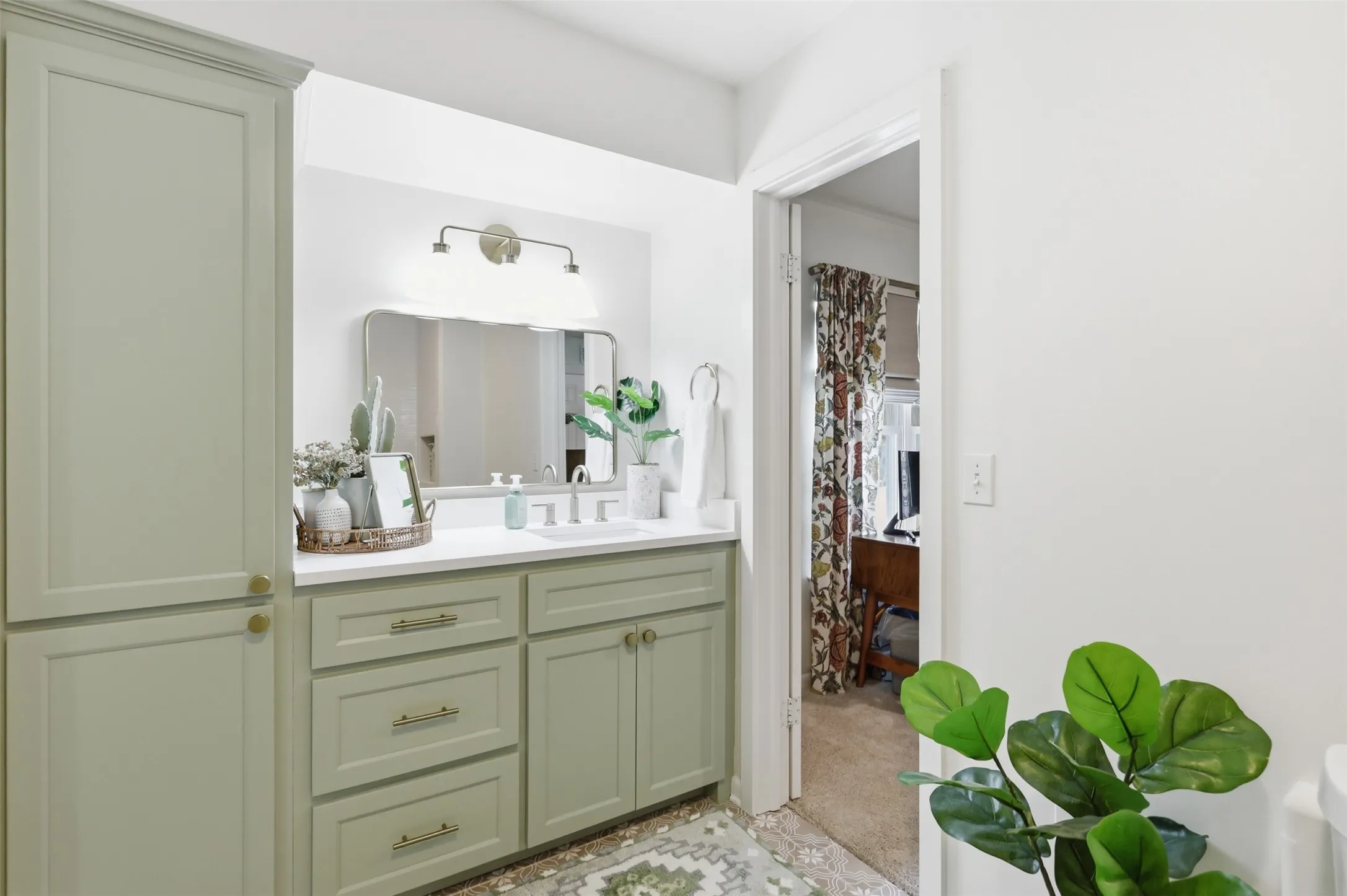 Jack and Jill Bathroom Connects the Secondary Bedrooms.  Renovations Include Beautiful Tile Floors, Custom Built Ins, and Shower/Tub Combo with Decorative Tile Inlay and Shelf.
