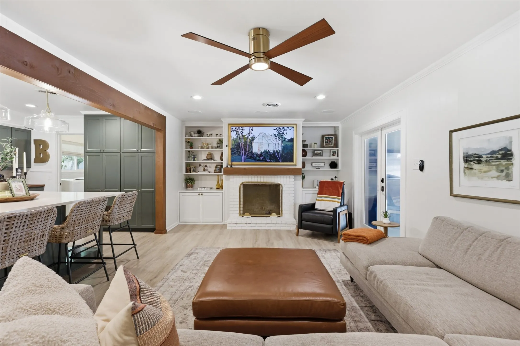 Fireplace and bookshelves have been painted with wood mantle added in 2023.  Luxury Vinyl Plank Flooring throughout the living areas creates seamless transitions.