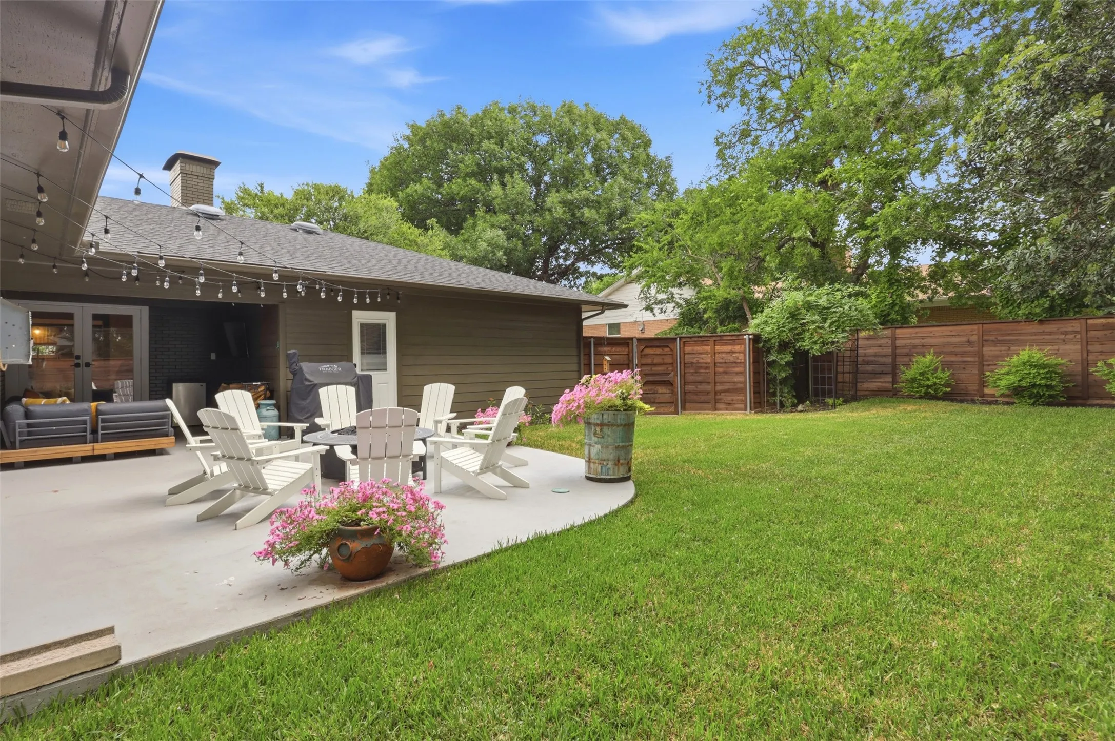Beautiful covered back patio with room for sitting area and fire pit.  New Fence creates a private space for enjoying family time.