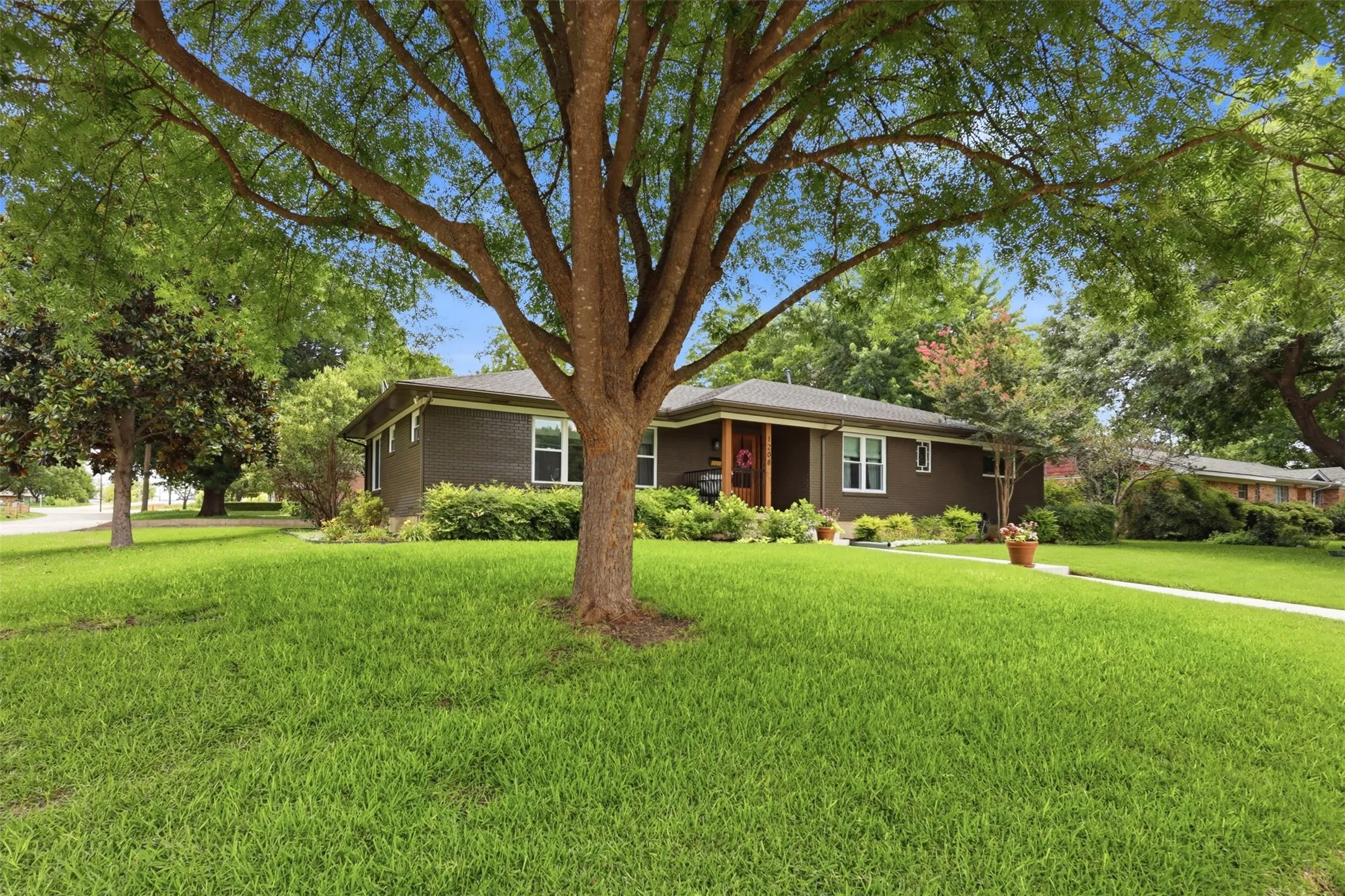 Welcome Home to this gorgeous mid-century modern home with large mature trees including magnolia tree and landscaping.