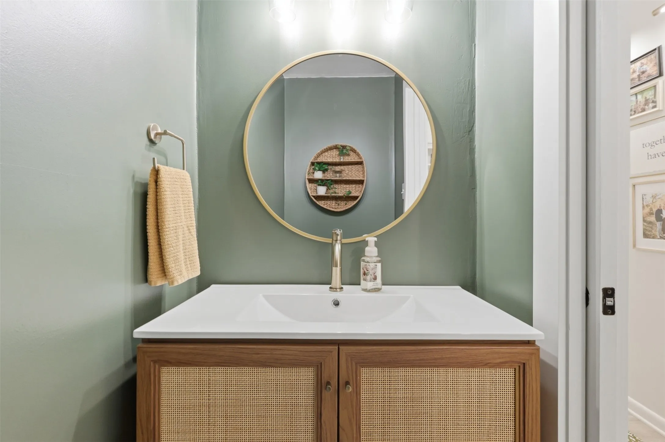 Half Bath with Pocket Door, Beautiful Vanity, Decorative Lighting and Mirror, as well as New Hardware.