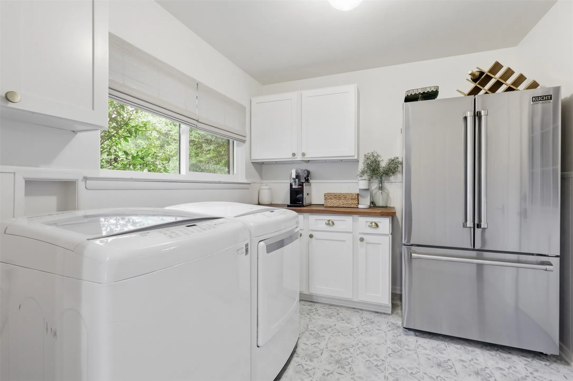 Large Utility Room with Built In Cabinets, Industrial Grade Fridge will Convey with Property, Decorative Tile and Butcher Block Countertops.