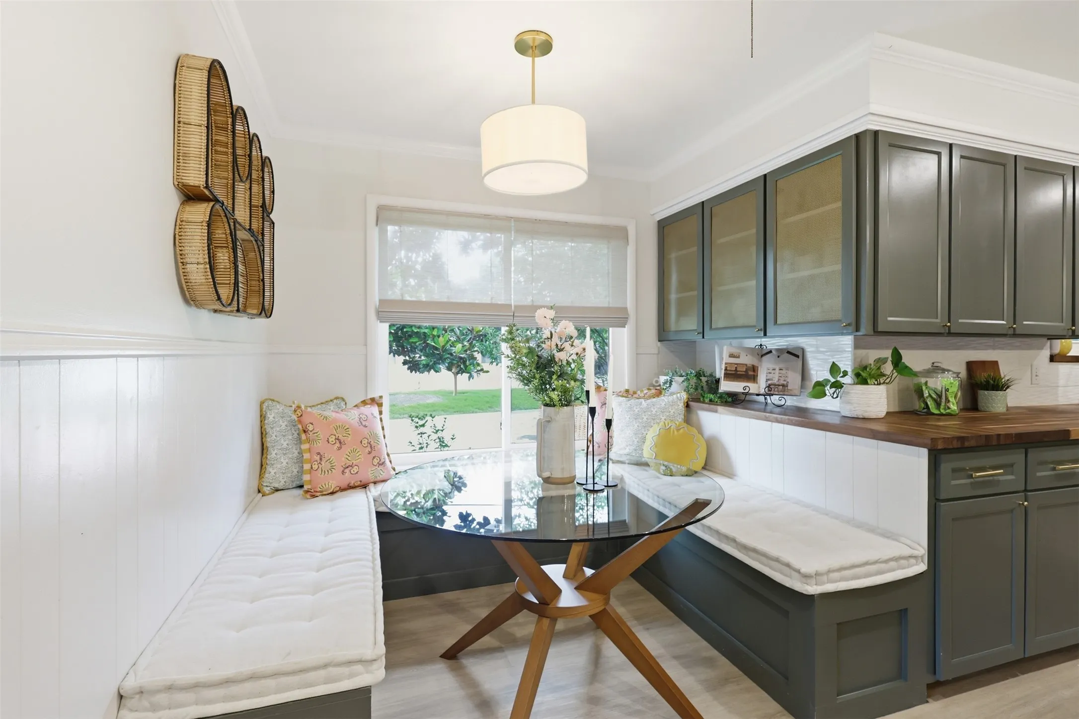 Alternate View of Banquette with cabinets covered by metal inserts that were replicated to mirror the original ones in the home.  Decorative lighting and custom shades finish off the inviting space.