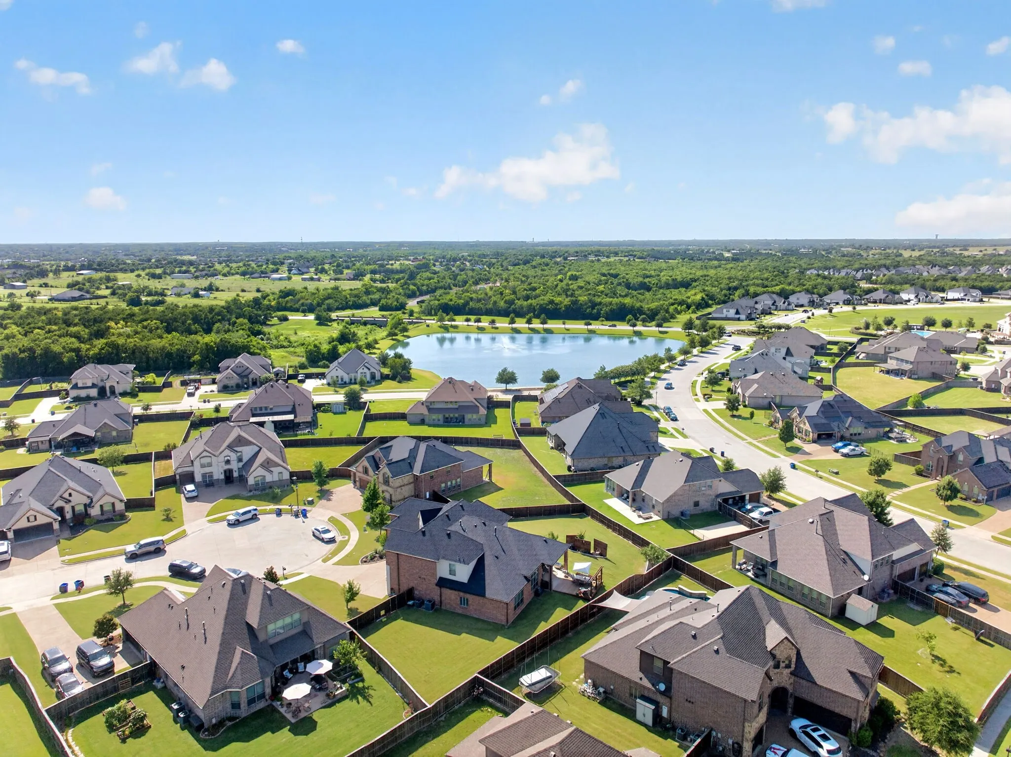 Expansive residential neighborhood featuring a central lake