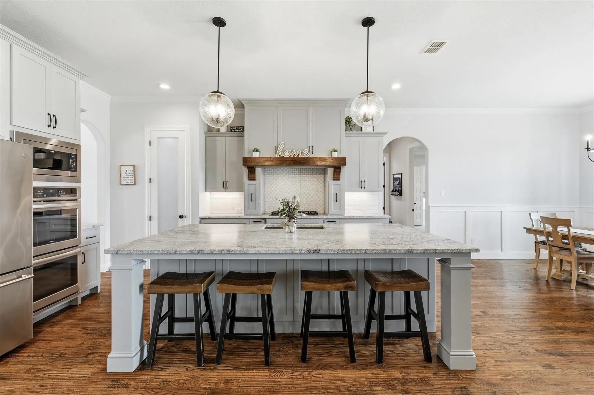 Kitchen island featuring a substantial countertop and pendant lighting