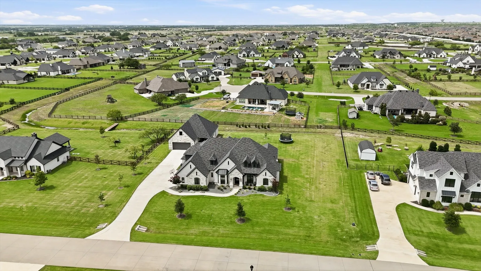 Expansive residential development featuring numerous single-family homes on large, green lots