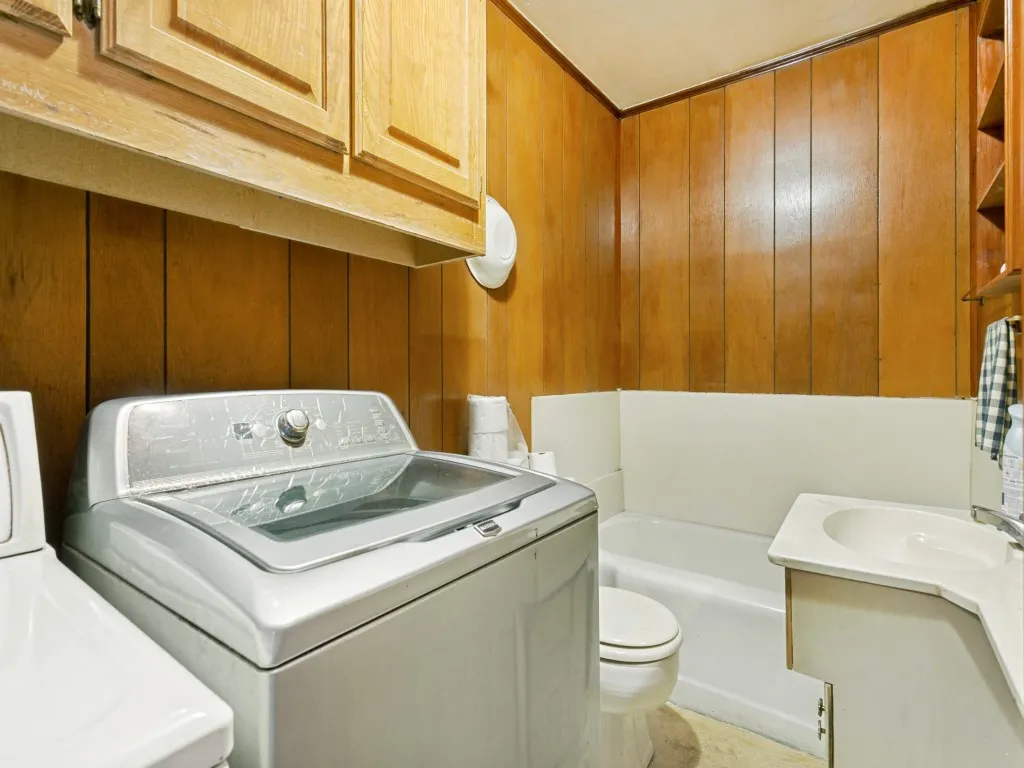 This full bath is off the family room and has a full-size washer and dryer set.