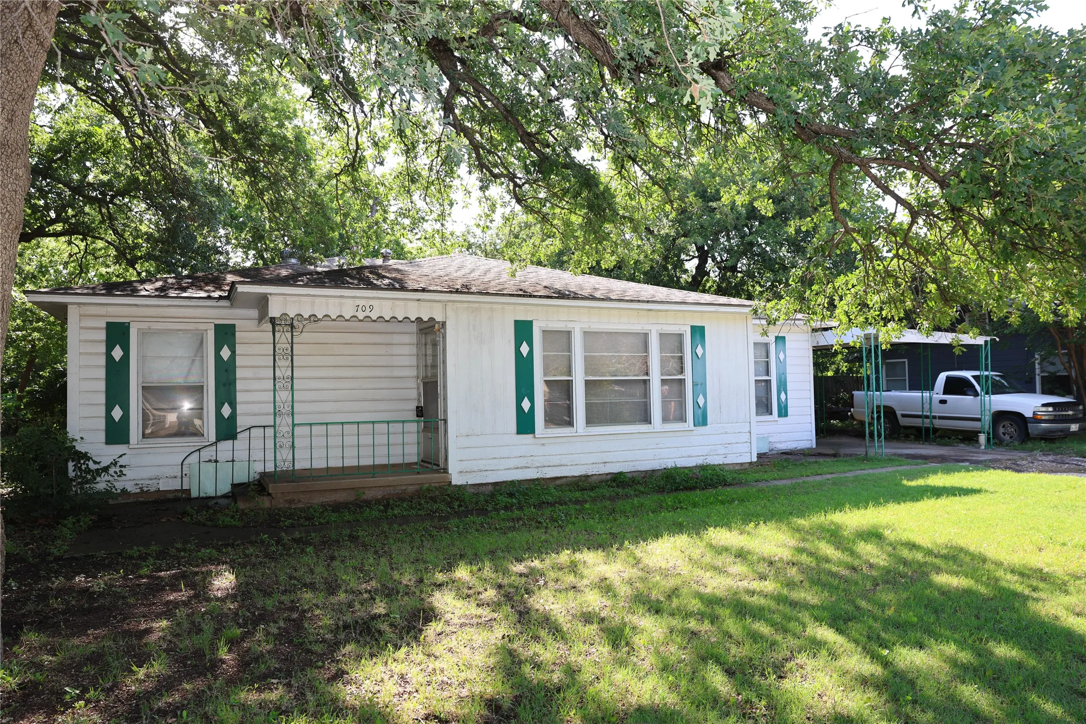Large tree in the front provides cooling shade for the home.