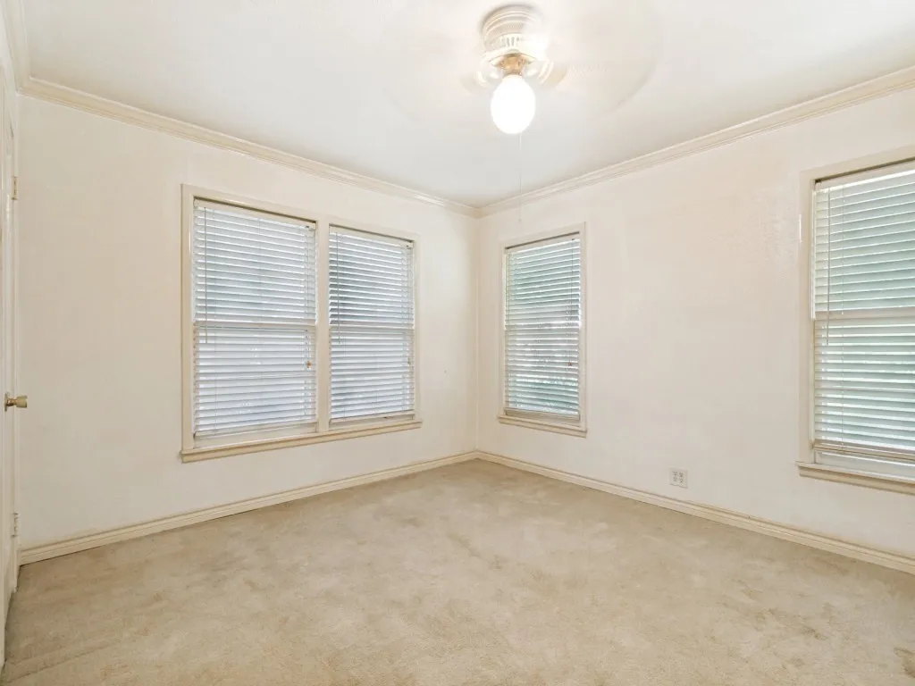 The back corner bedroom has a ceiling fan and large closet.