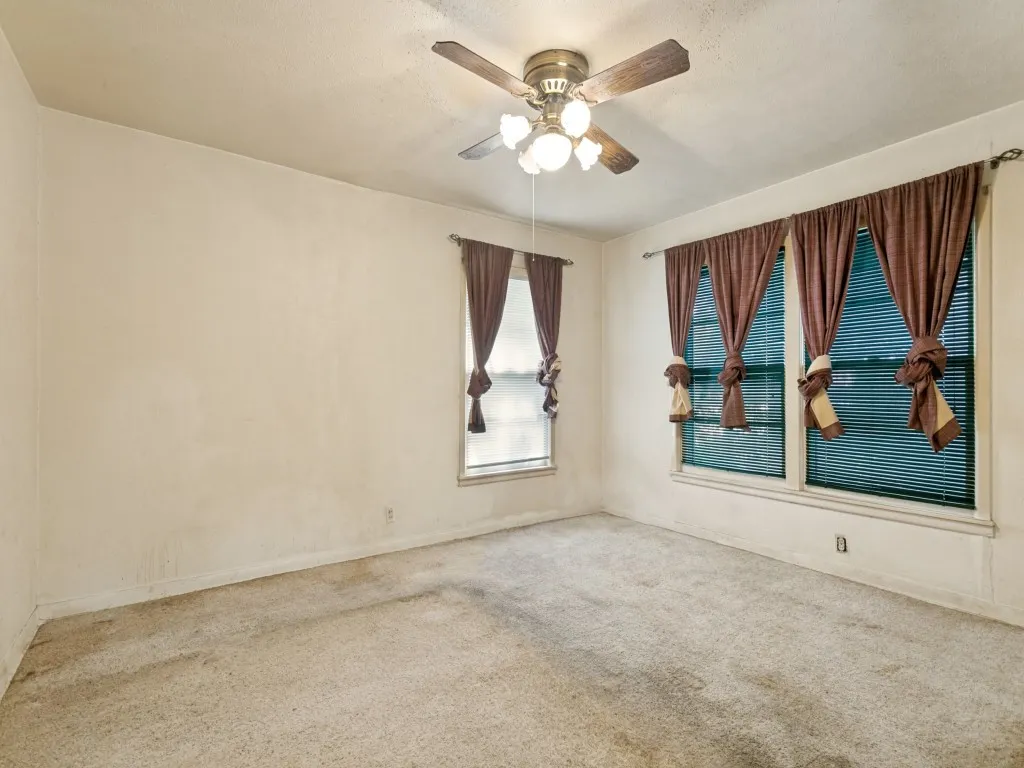 The front bedroom has three large windows, a ceiling fan and lots of space.