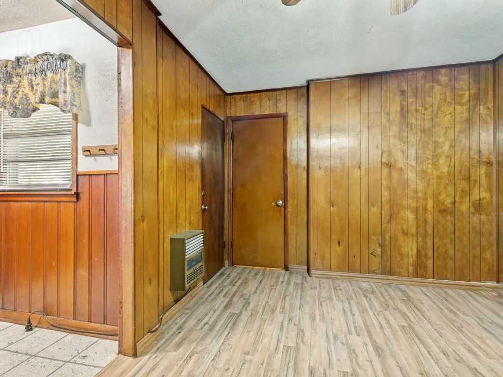 The large family room is just off the kitchen.  The door to the left opens to the covered back patio. The door on the right is a full bathroom with a washer and dryer.