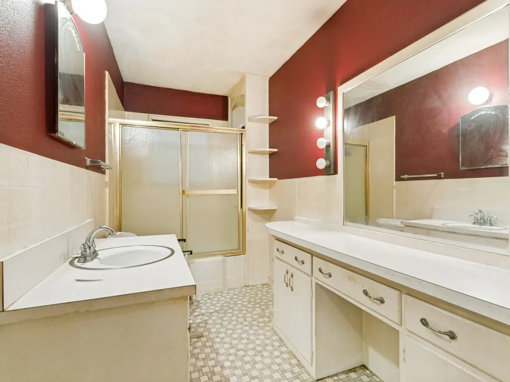 The large hall bathroom is easily accessible from all bedrooms and the front living area.  It features a long countertop with vanity, a medicine cabinet, shelving and a tub/shower combo