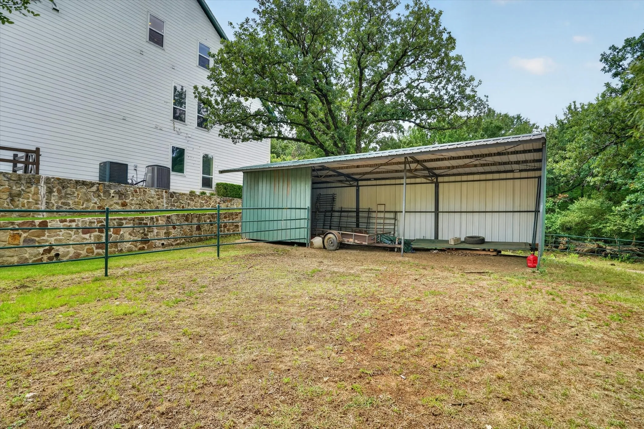 Open-sided metal shed with a pitched roof