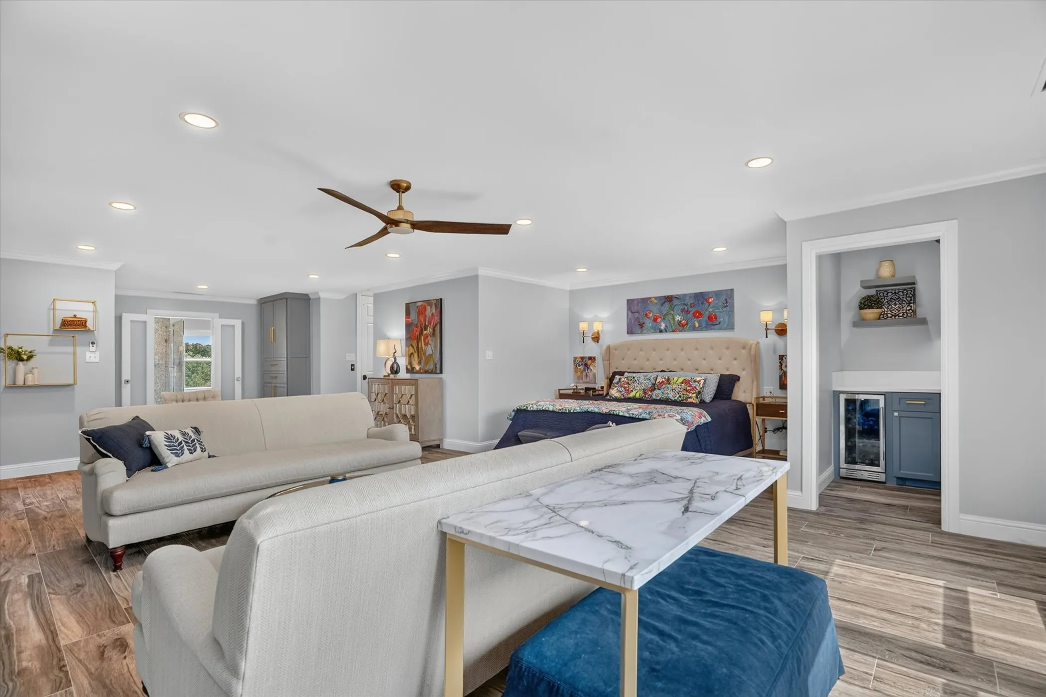 Expansive room featuring wood-finish flooring, recessed lighting, and a contemporary ceiling fan