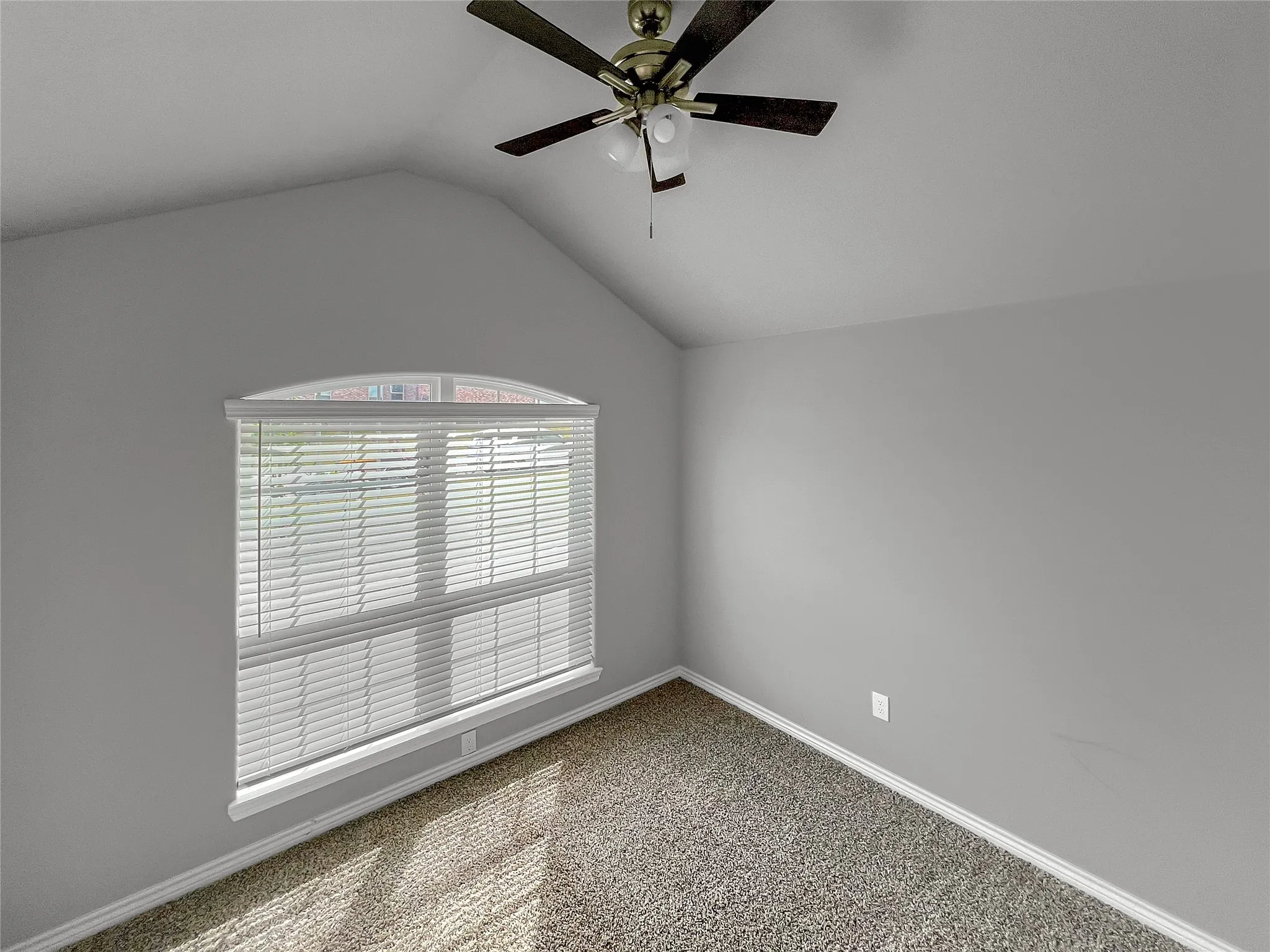 Room featuring vaulted ceilings and a ceiling fan with integrated lighting