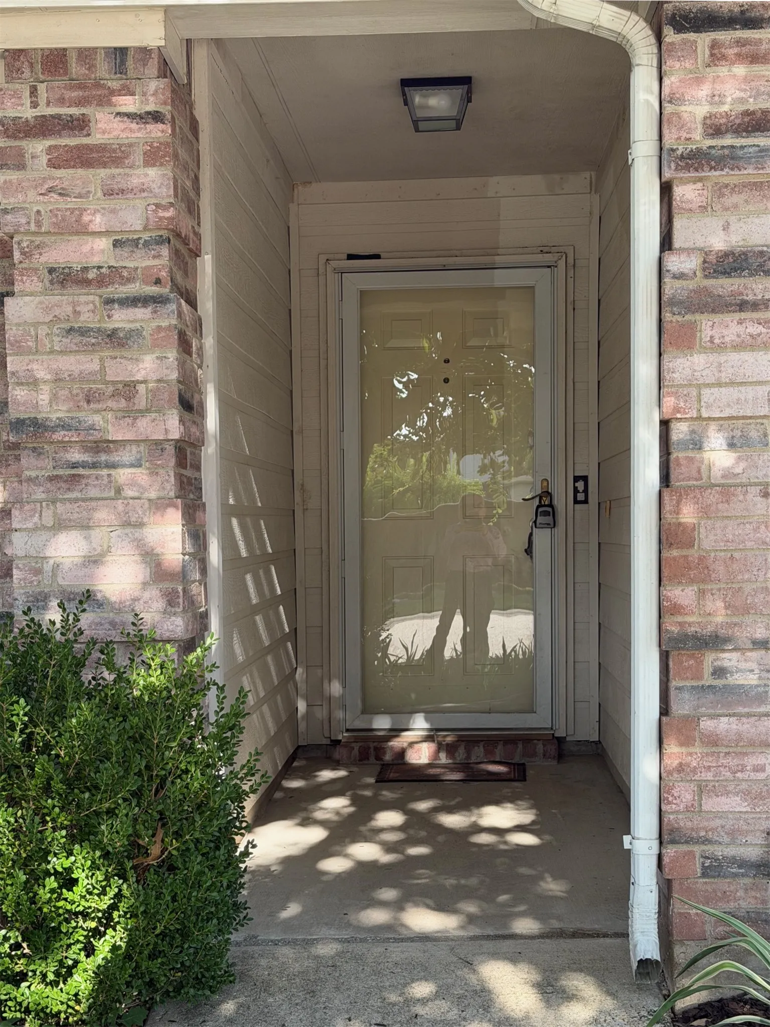 Brick and siding exterior featuring a covered entryway