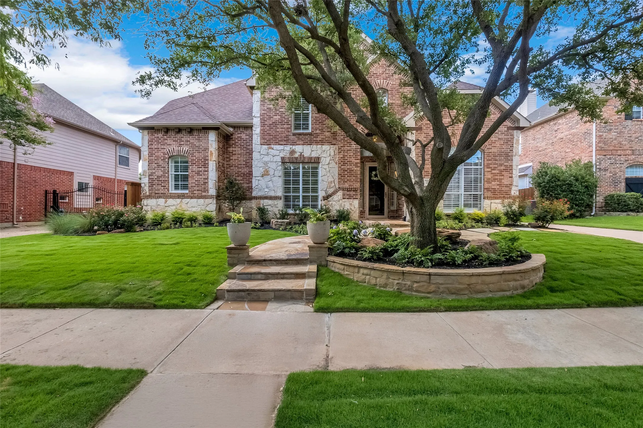 Beautifully maintained and landscaped front yard with a two-stone facade on a quiet street