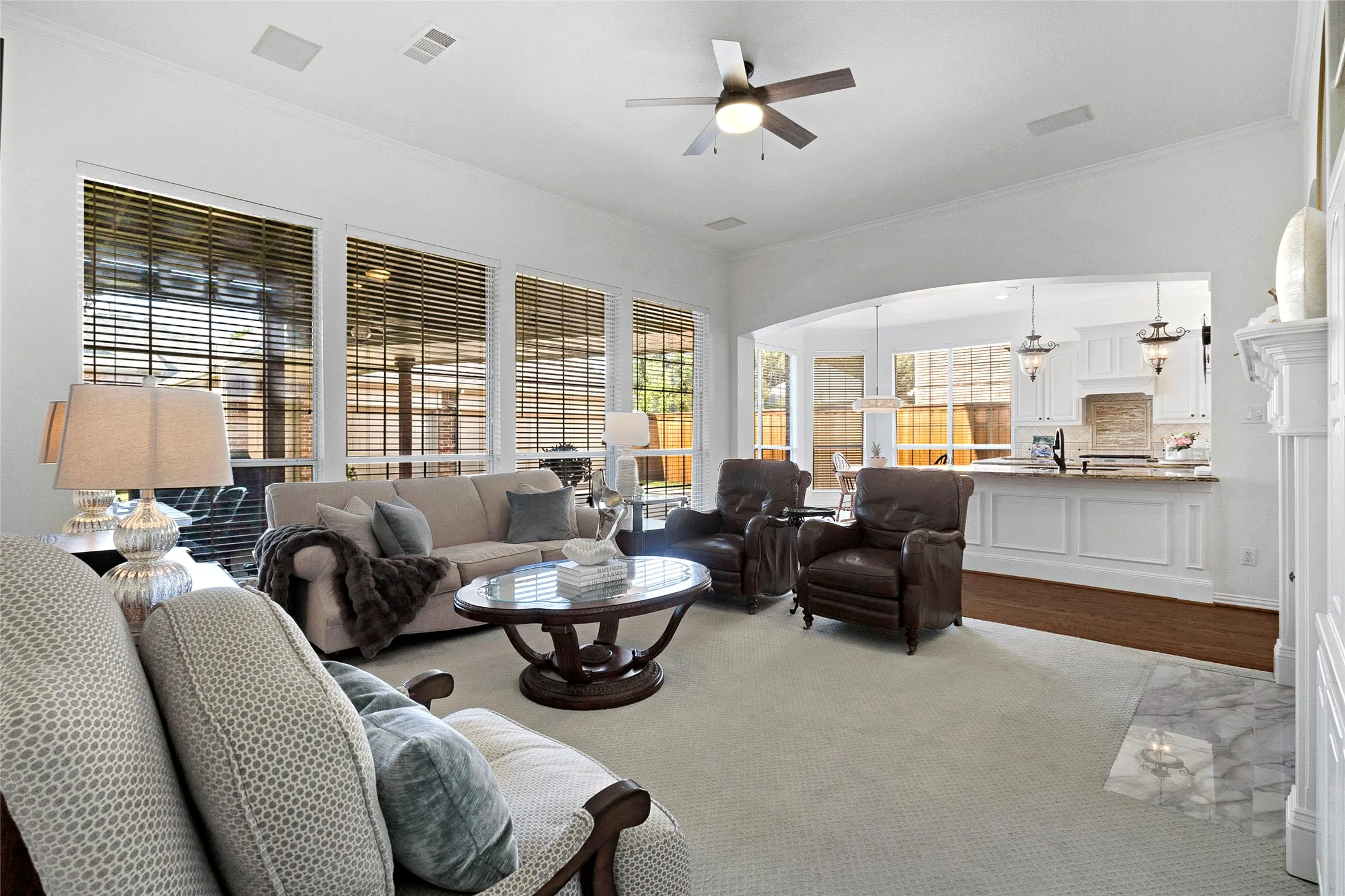 A large open family room with 4 large windows connecting you to the heart of the home.  A beautiful gas log fireplace and builtin completes the room.