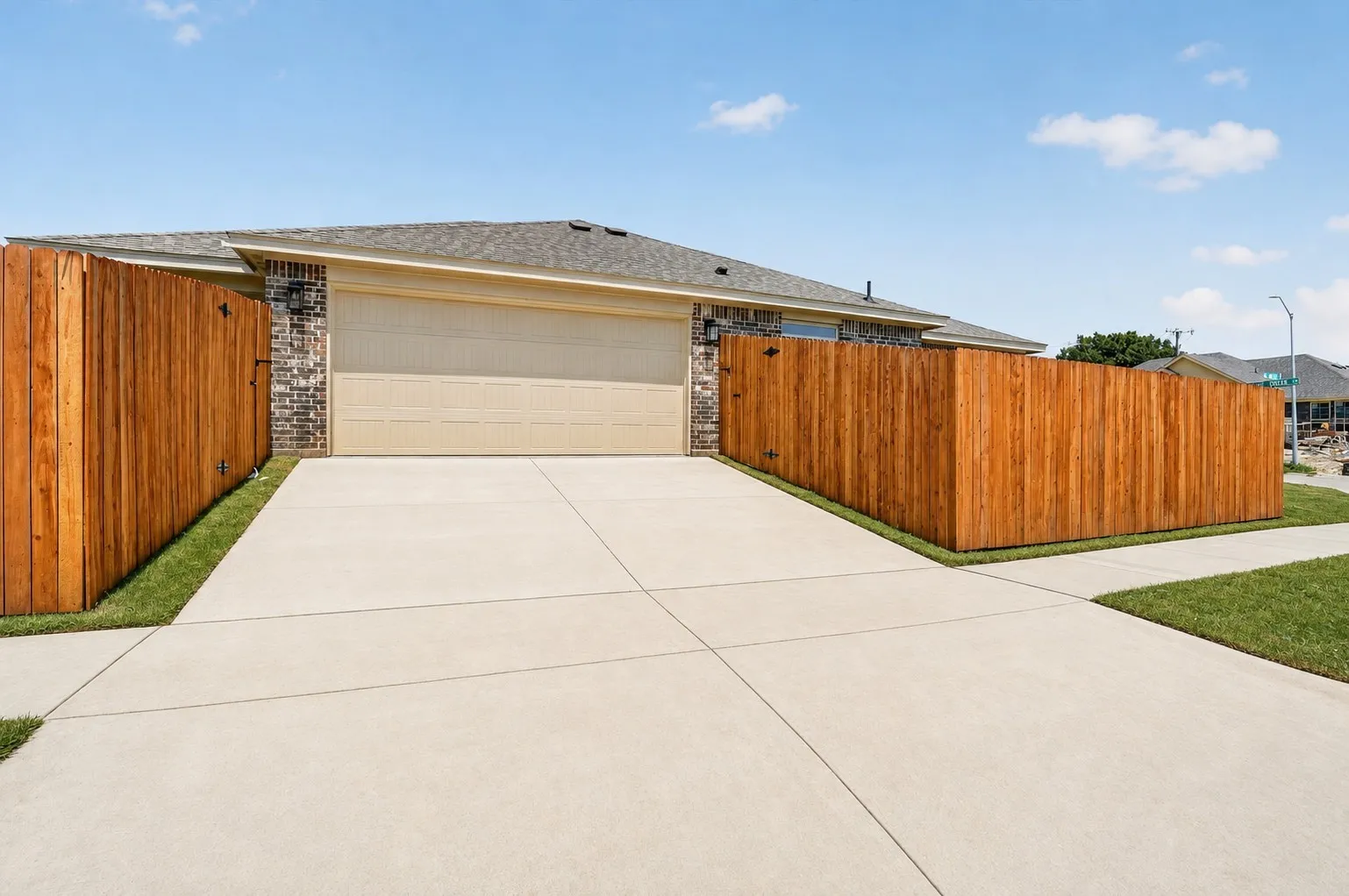 Brick exterior with stone accents, an established lawn, and a concrete walkway leading to the entrance