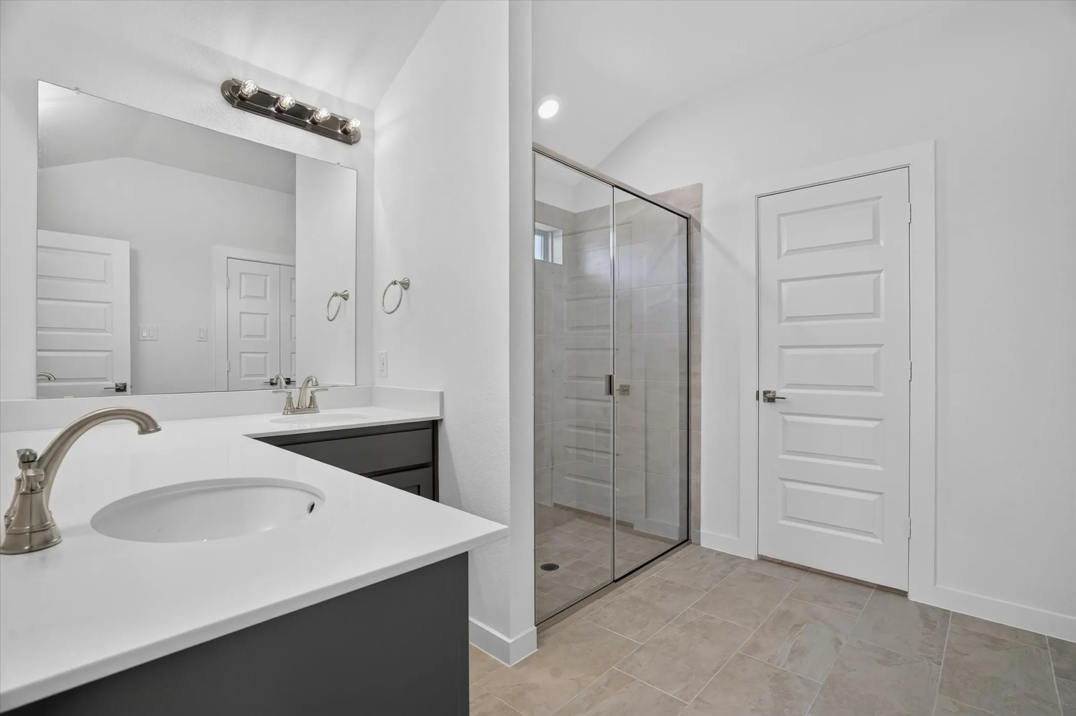 Double vanity featuring white countertops, undermount sinks, and brushed nickel fixtures