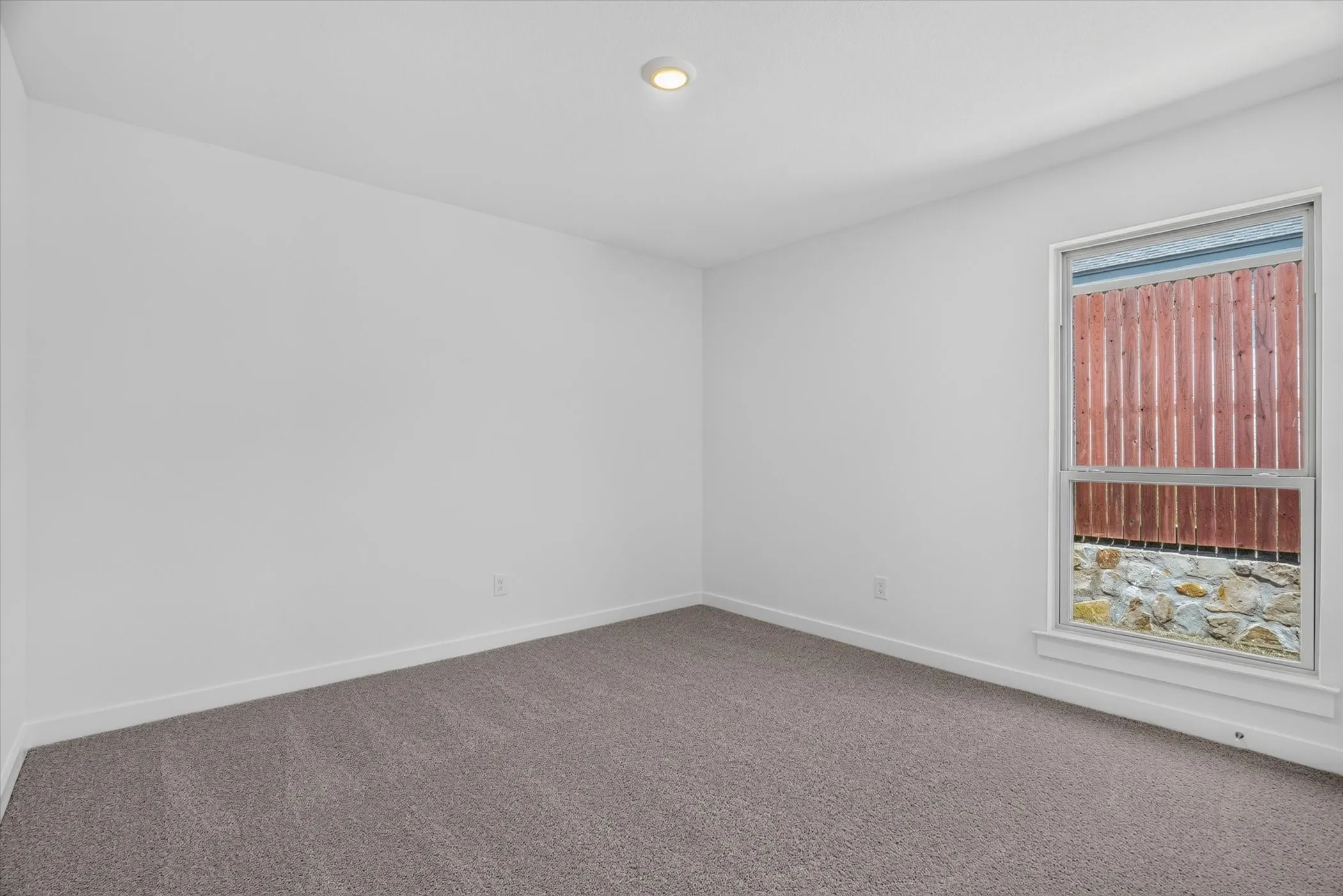 Spacious bedroom with neutral wall finishes, recessed ceiling lighting, and plush carpet flooring