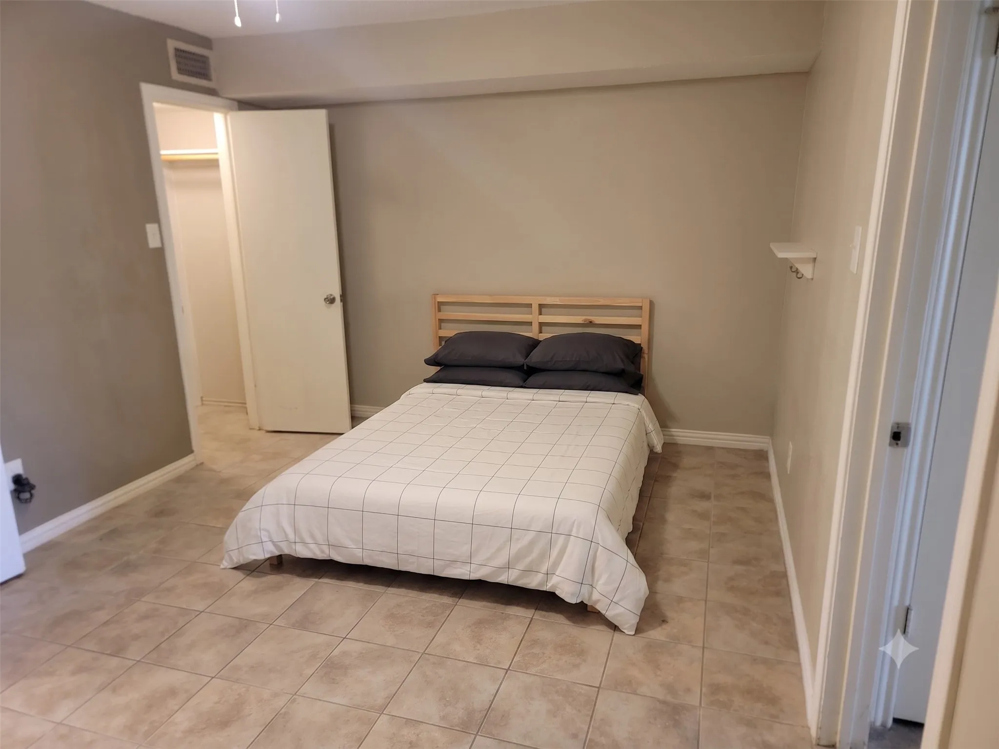 Neutral-toned walls complement the tile flooring