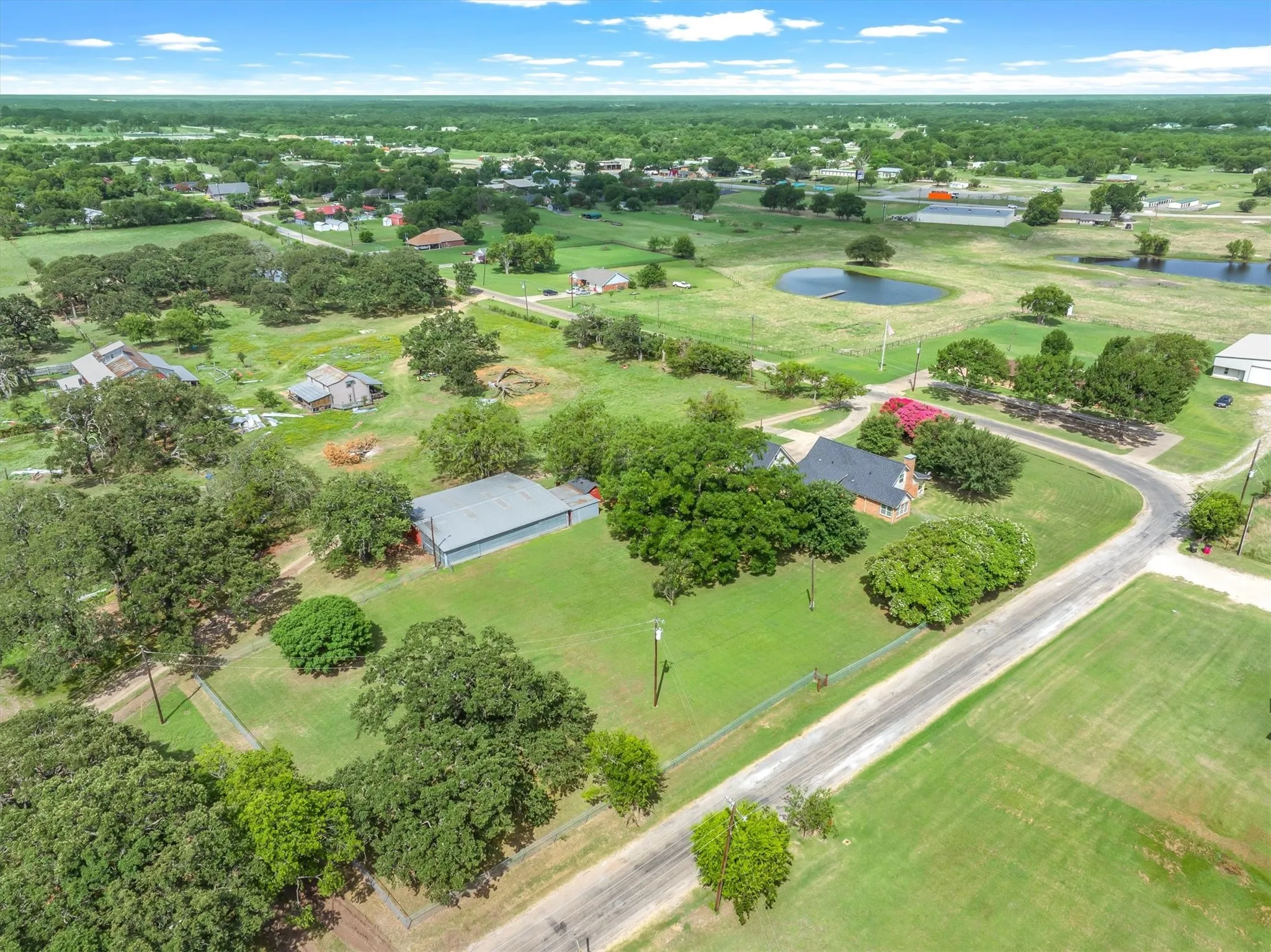 View of back yard, workshop, and home.