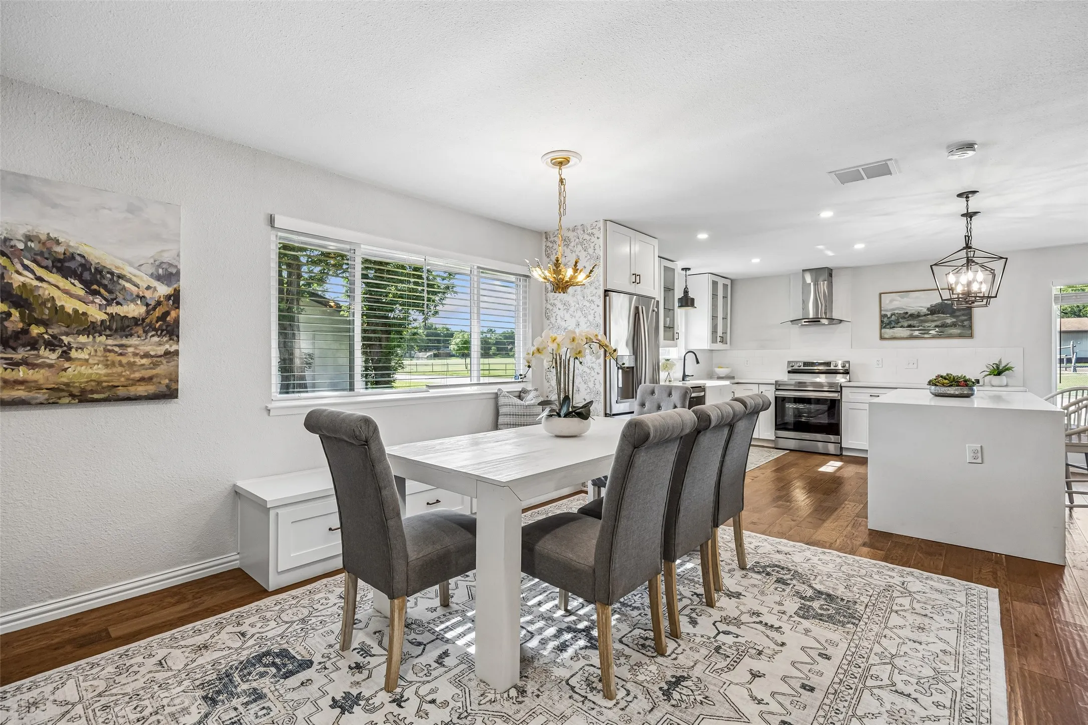 Chic bench seating, with more built-in storage, is topped by large windows for dining views.