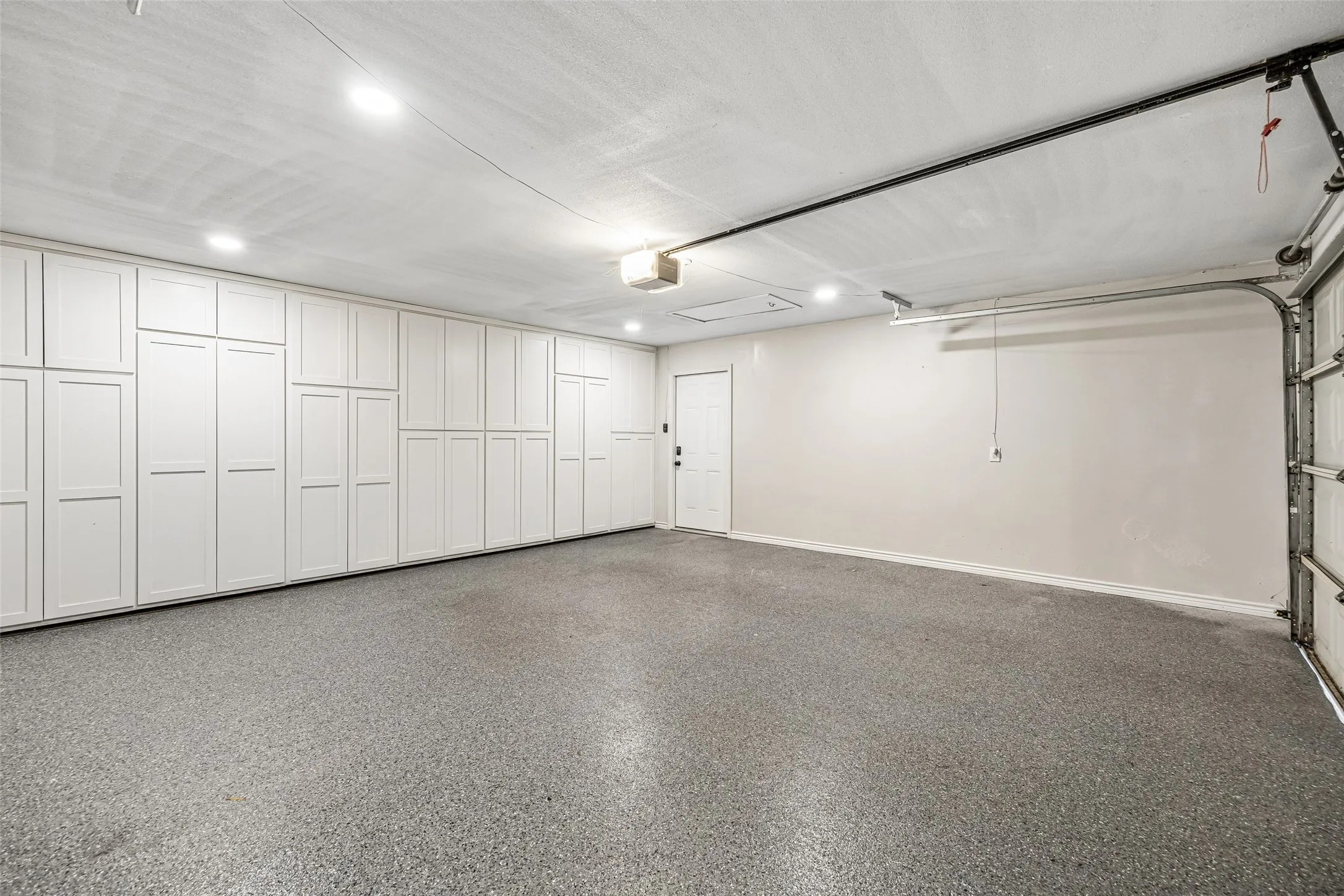 Check out this garage! Epoxied floor and dreamy storage space. Just think...easy access to tools and holiday decorations. Although there is ample attic space no climbing and hauling to and from the attic is necessary.