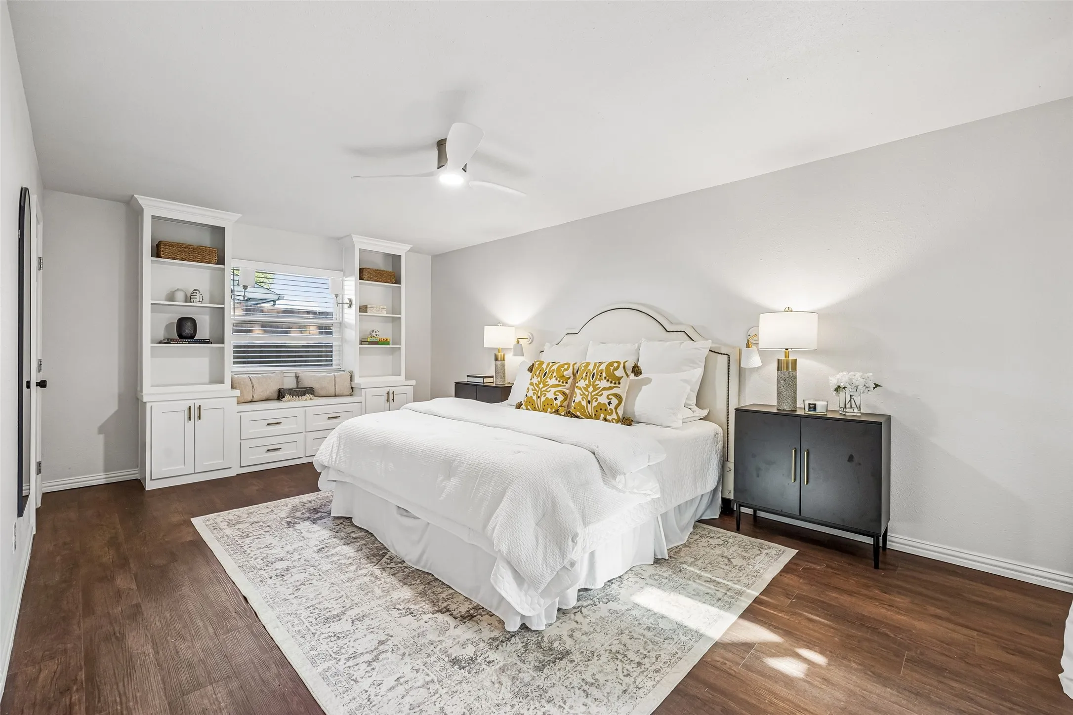 The primary bedroom is generously sized for king-sized furnishings with room to spare for additional seating. Of course, more custom built-ins with chic bench seating and a large window for natural light.