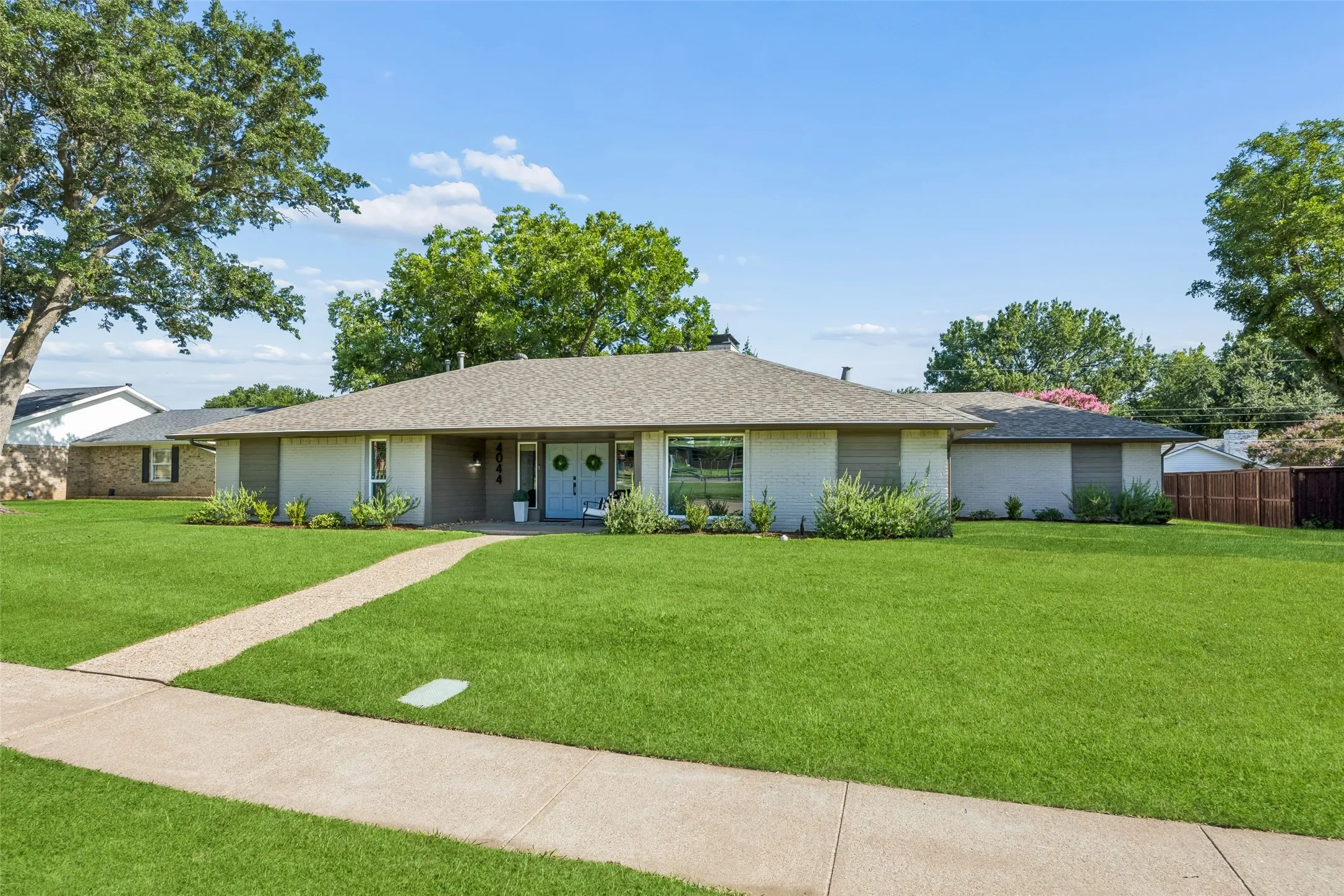 Neatly tailored curb appeal is inviting and easy to care for. Check out the extra large covered porch with double door entry.