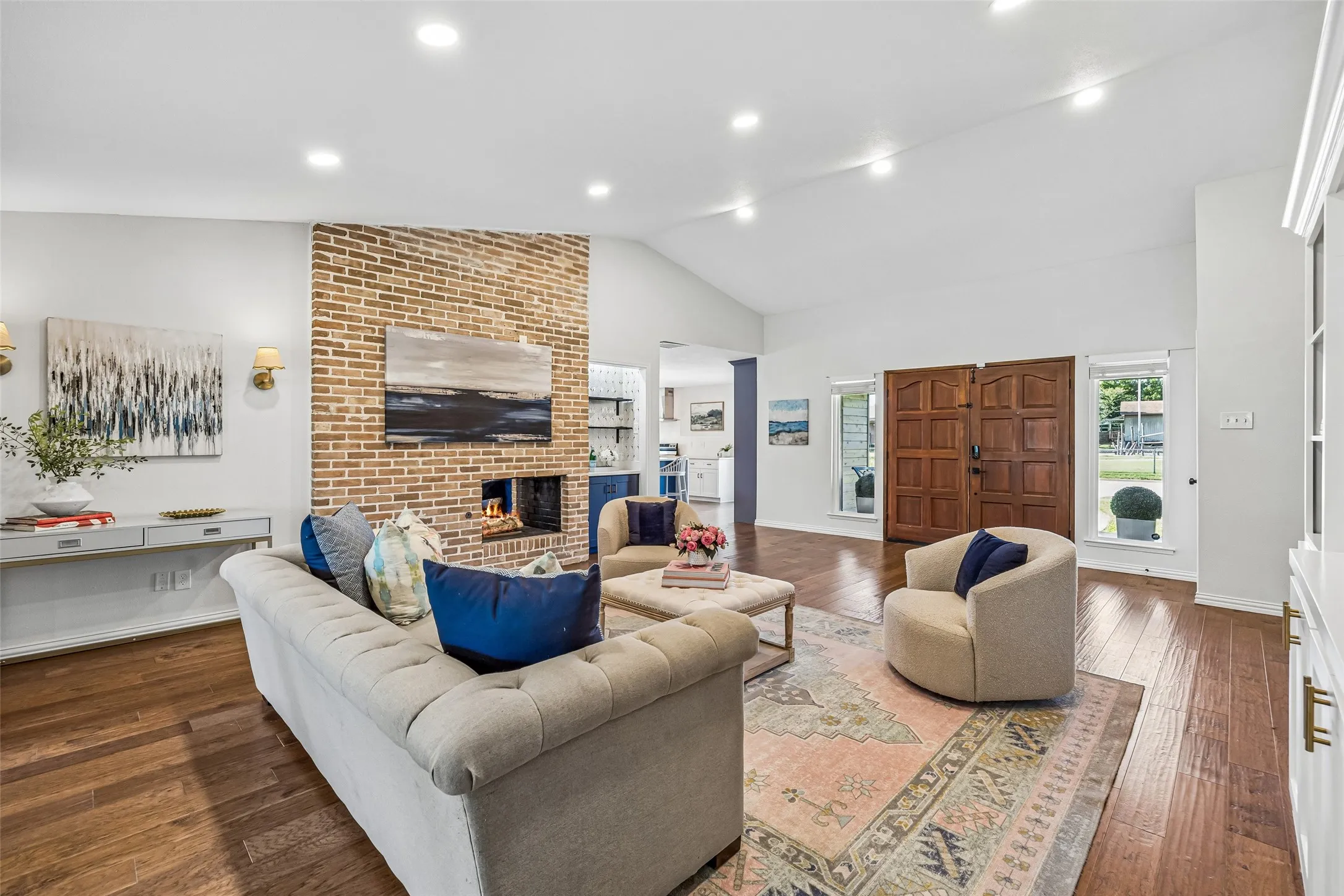 Two large windows with welcoming front yard views flank the double entry doors and add visual symmetry.