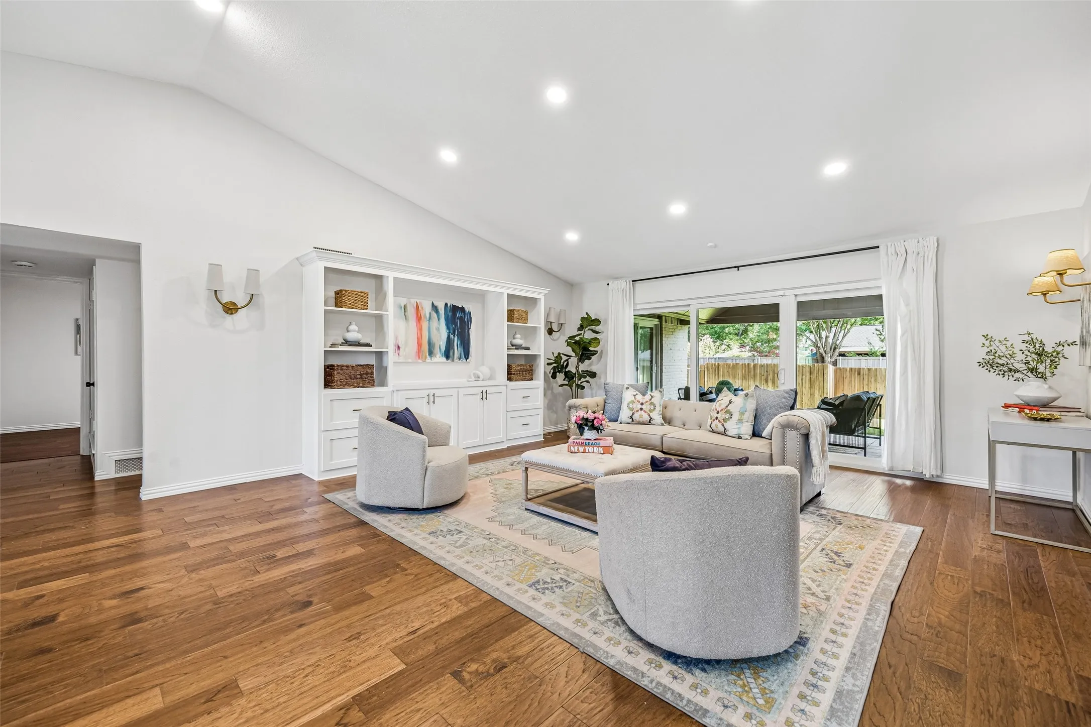 Rich, warm flooring unifies the entire home. Notice the high ceiling, providing visual space.