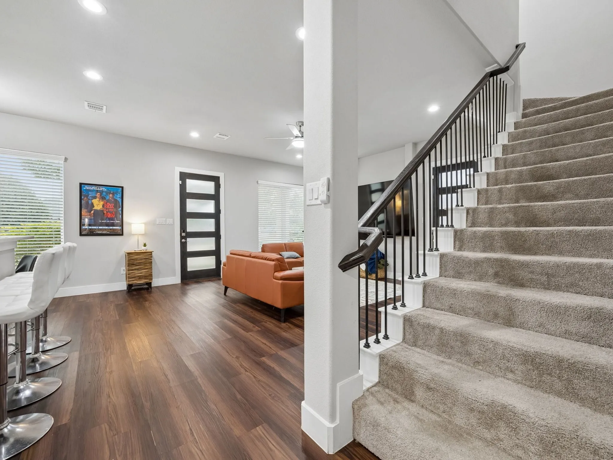 Wide carpeted staircase leads to 4 upstairs bedroms and flex space