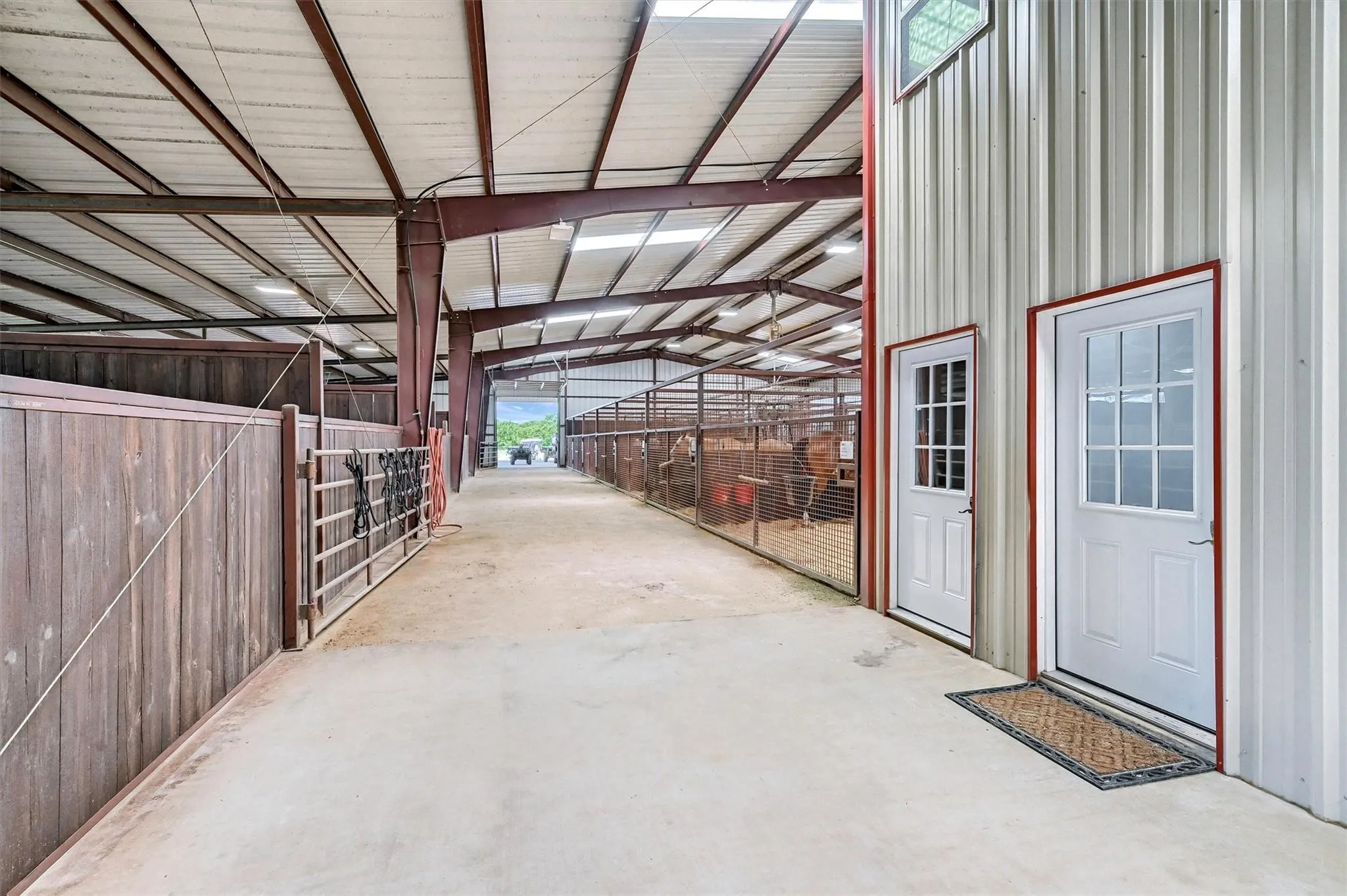 72-stall horse barn has a breeding lab, vet stocks, wash rack, steel mesh stalls, fans.