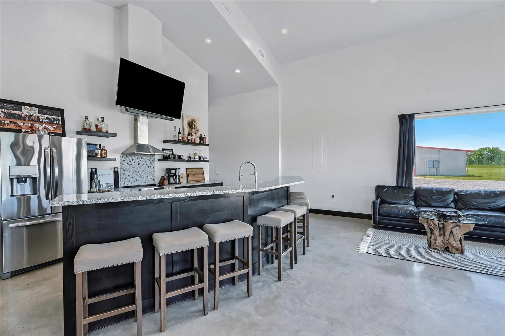 Luxury visitors lounge with a sit-at bar and full kitchen facilities.